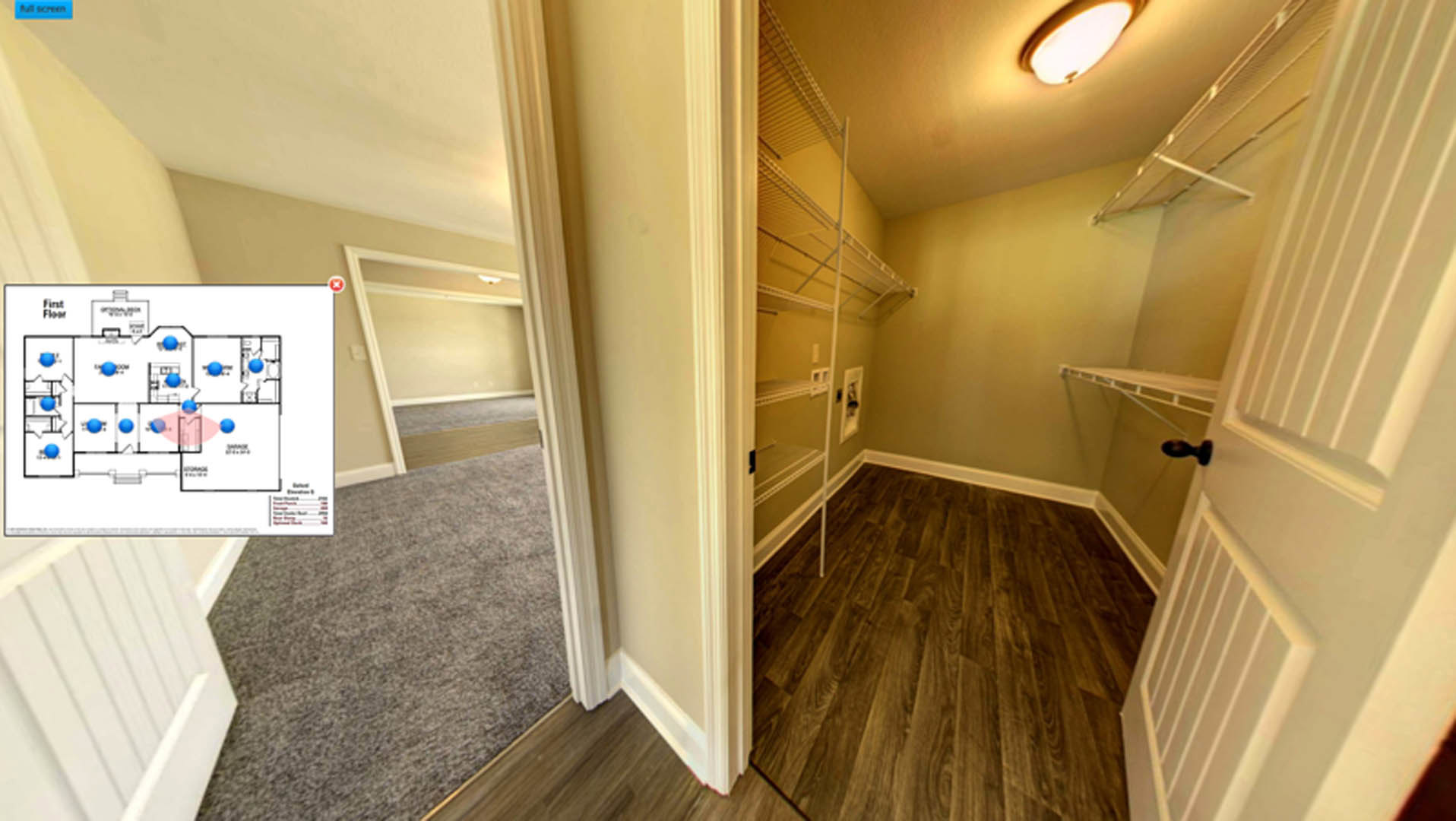 Open room with light wood flooring, built-in white shelves along one wall, white baseboard trim, and neutral painted walls