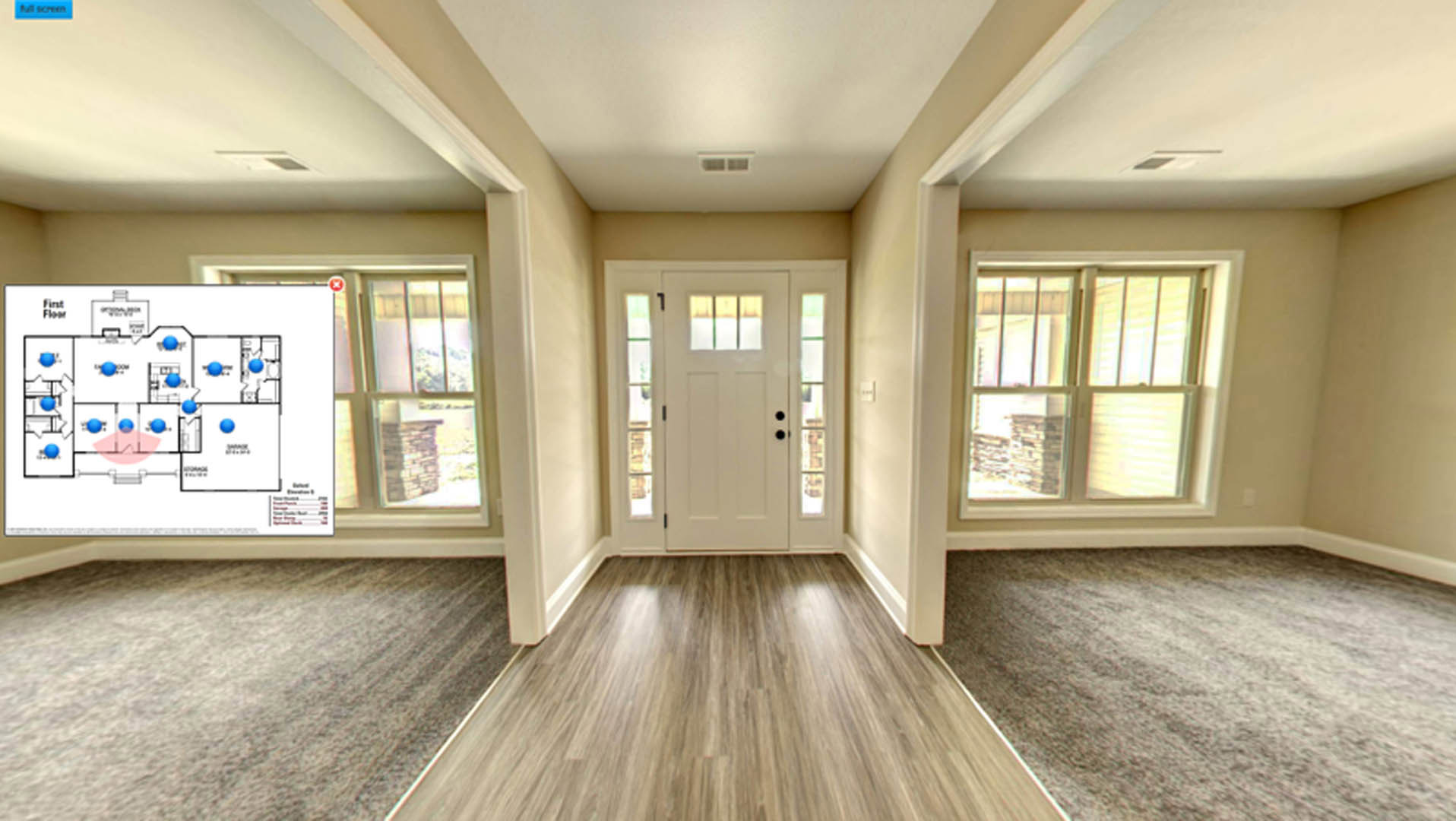 Hallway with wood flooring, white framed windows, and a white door with glass panels; natural light reflecting on the floor.