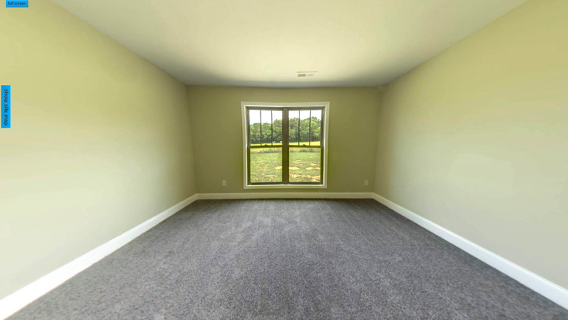 Bright room with large window overlooking grassy field, grey carpet flooring, white walls, ceiling vent, and trees visible outside