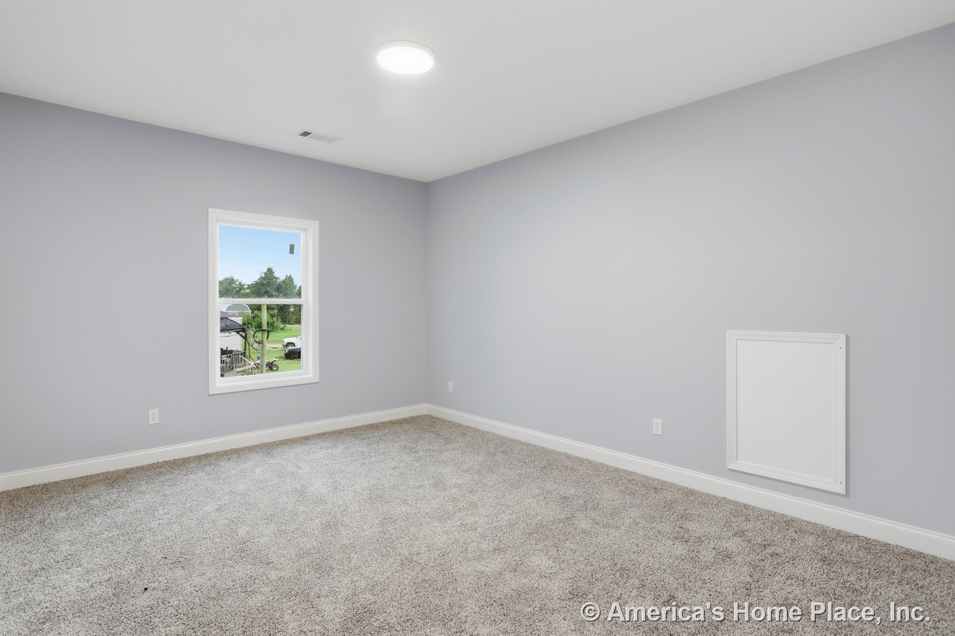 Bedroom with light gray walls, carpet flooring, white trim and baseboards, single window with white frame, flush ceiling light fixture, and wall access panel.