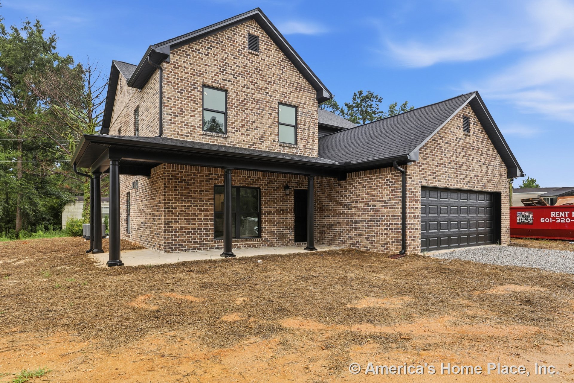 Brick siding with black framed windows, covered front porch supported by columns, black garage door, gable roof with shingles, and concrete porch floor at front entry.