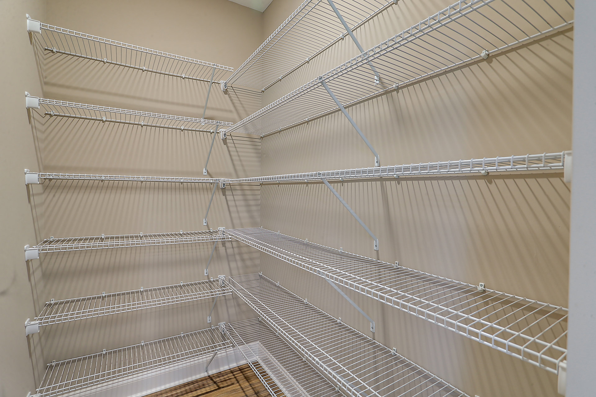 White metal shelving unit mounted on a wall in a modern indoor room