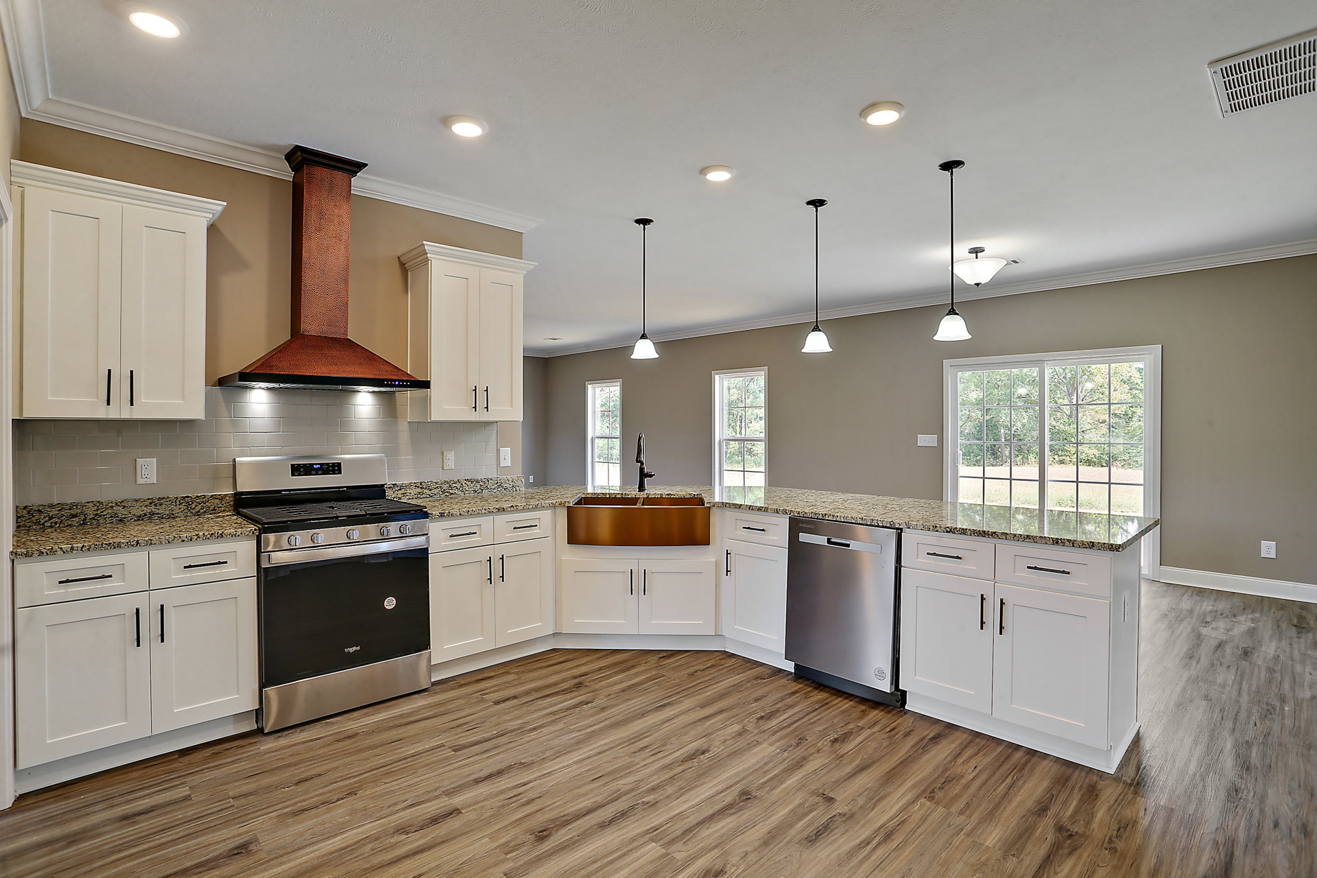 White kitchen cabinets, marble countertop, stainless steel dishwasher, black door stove, copper chimney, and sink