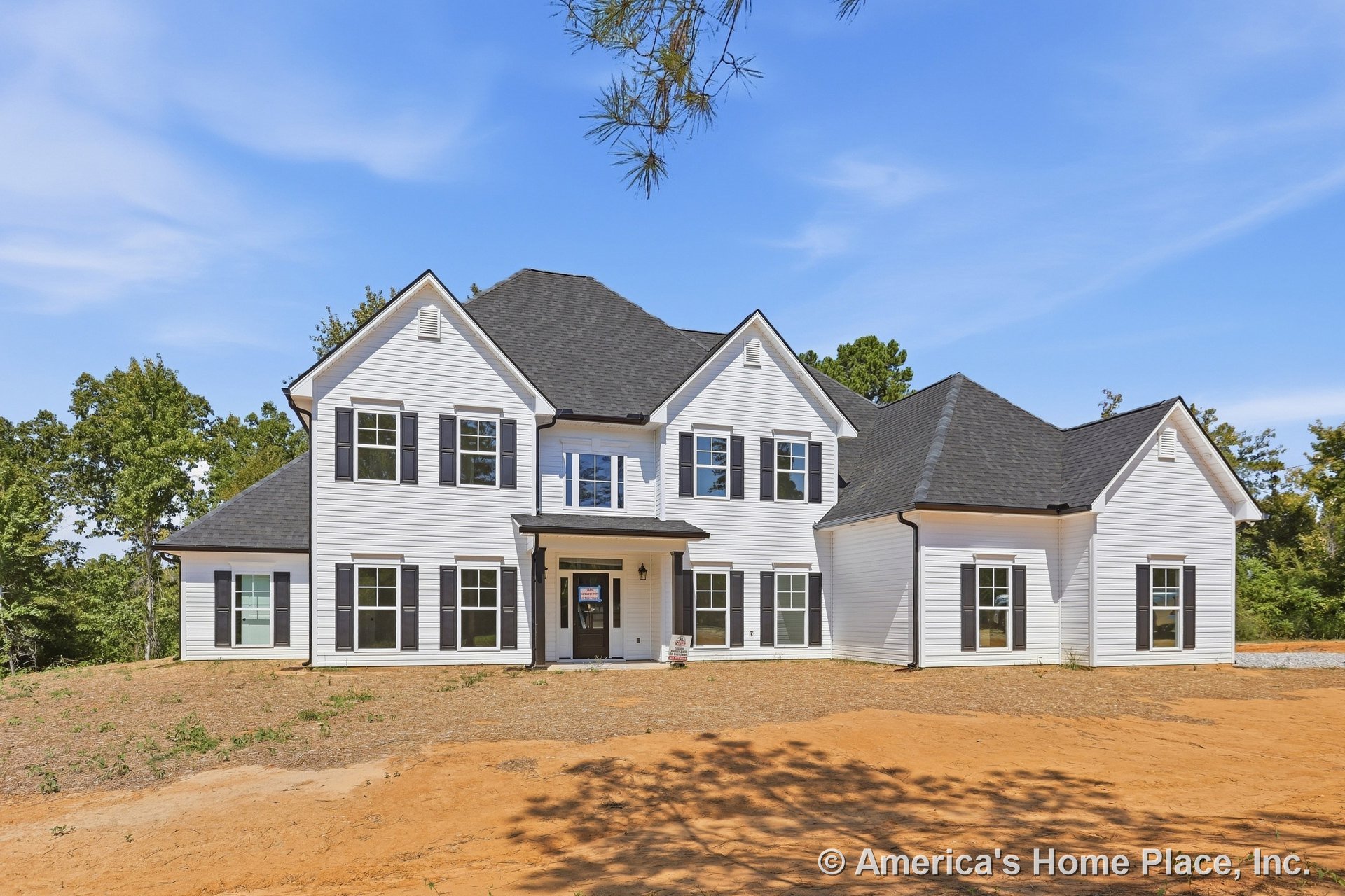 White horizontal siding with black shutters, multiple gabled rooflines with black asphalt shingles, white window trim, covered front porch with double black exterior light fixture