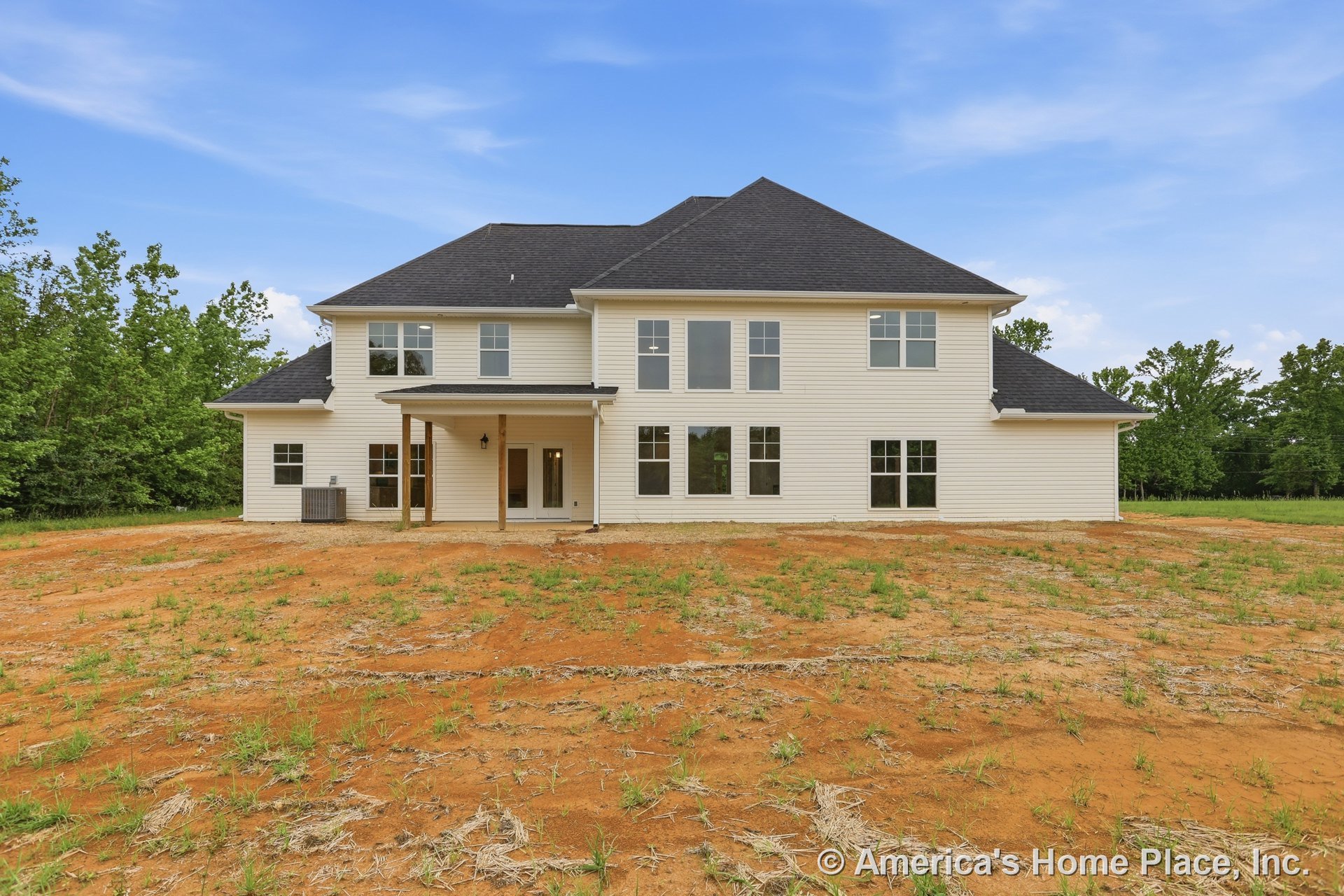 Two-story exterior with light-colored siding, dark shingle roof, multiple large rectangular windows, covered rear porch supported by wooden columns, exterior HVAC unit, outdoor