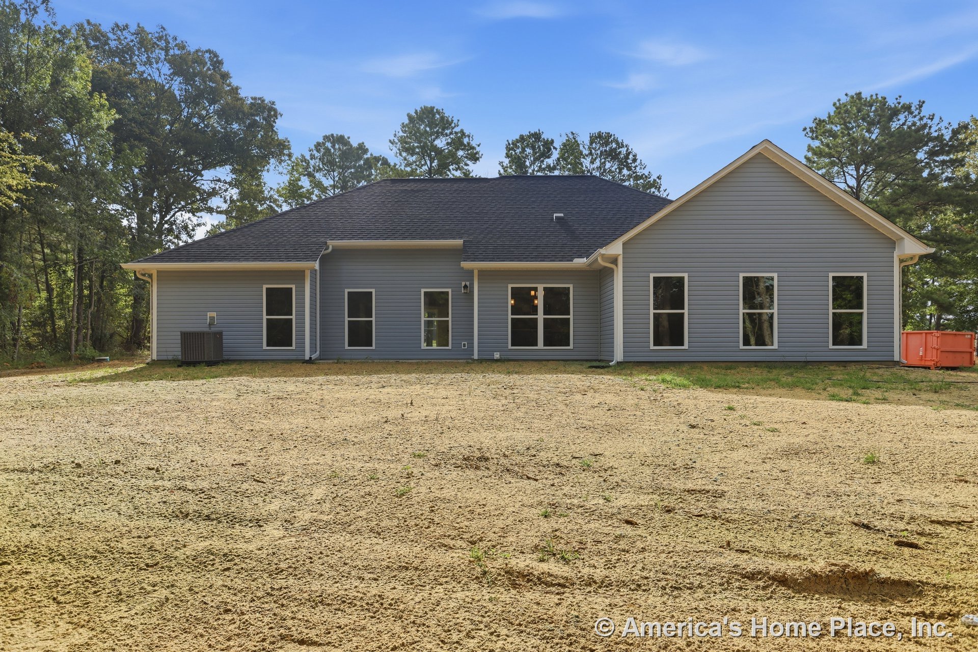 Gray vinyl siding with white trim, dark shingle roof, multiple large windows, rear exterior elevation, gutter system, single-story layout, outdoor air conditioning unit, new
