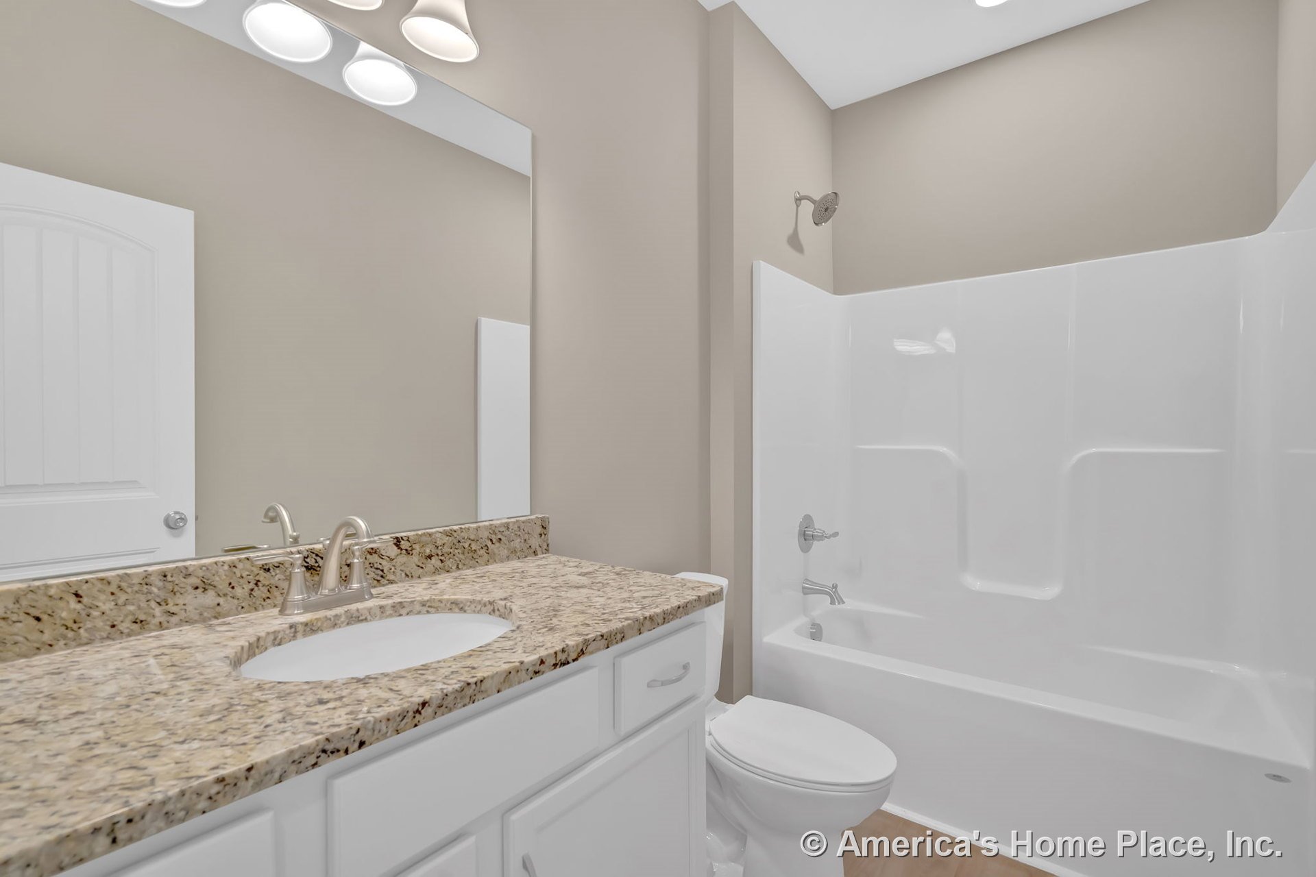 Granite vanity countertop with white shaker cabinets, large wall mirror above brushed nickel faucet, integrated molded tub-shower unit, overhead vanity lighting, neutral wall