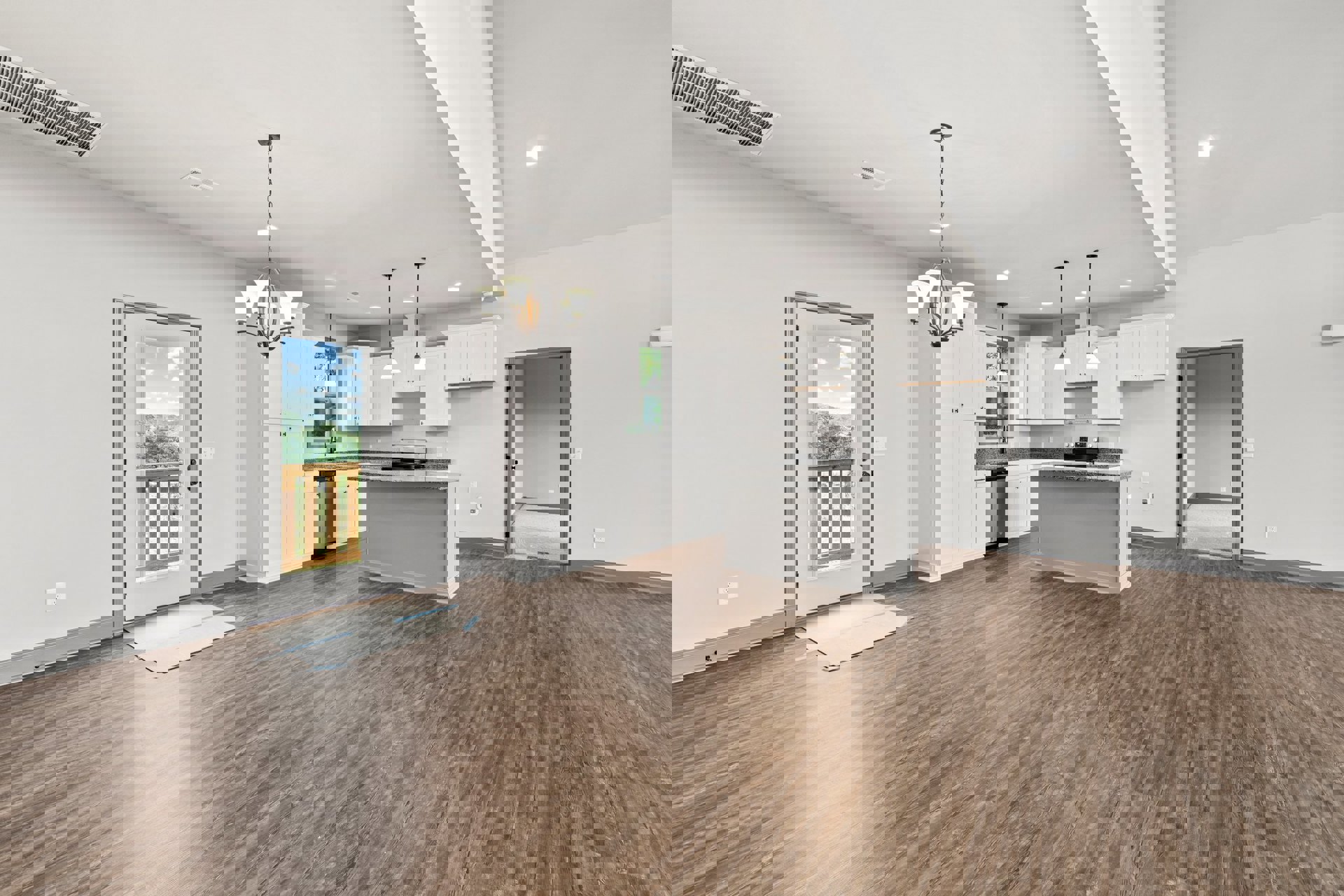 Open-concept kitchen and living room featuring white cabinets, wood flooring, a kitchen counter, and a door offering views of trees and blue sky; white cardboard with blue tape