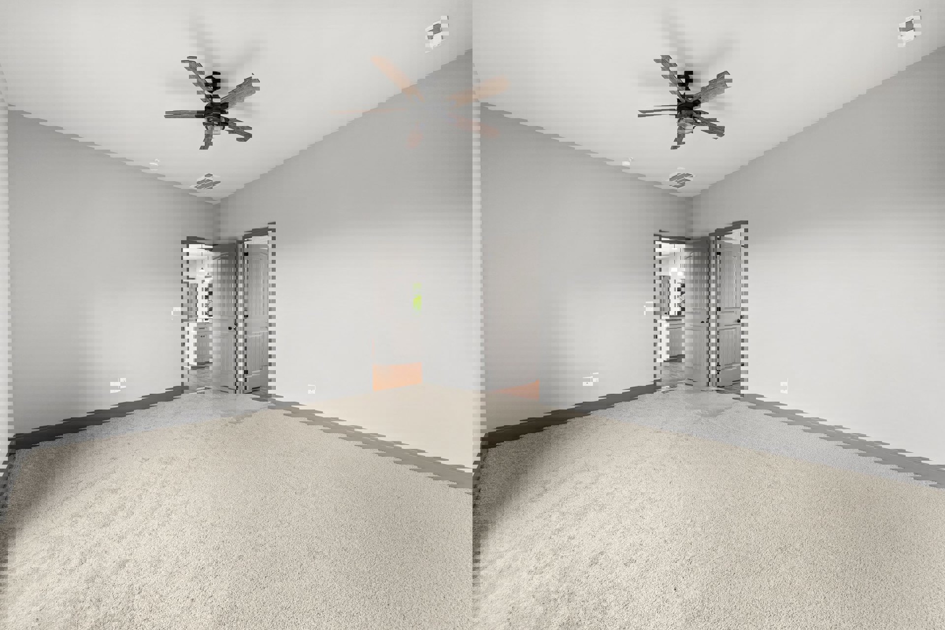 Neutral-toned carpeted room with white walls, ceiling fan with light fixture, white door featuring black hardware, and white air vent on wall