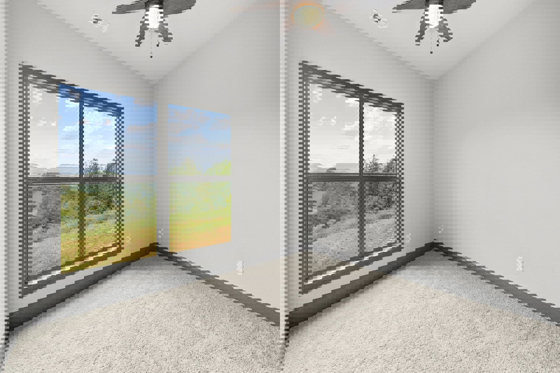 Neutral-toned carpeted room with white walls, large window overlooking greenery, ceiling fan with integrated light fixture, and white ceiling vent