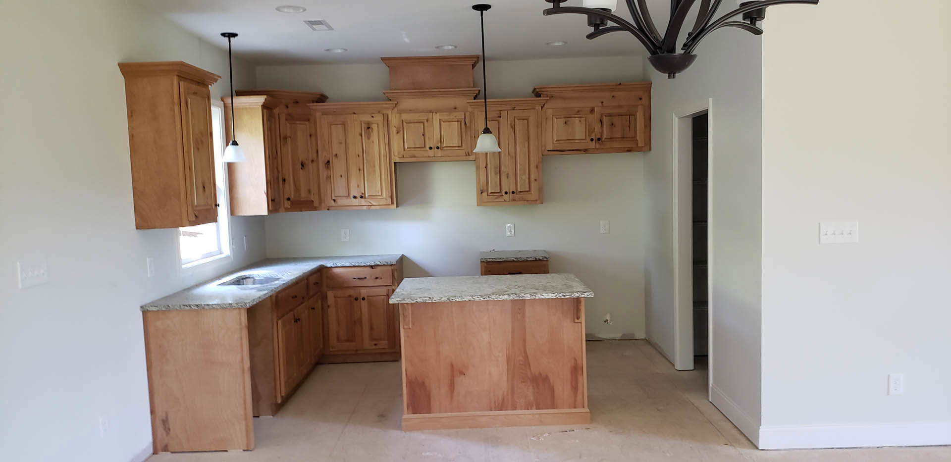 Kitchen featuring natural wood cabinets, white marble countertops, stainless steel appliances, undermount sink, and drawers with modern hardware