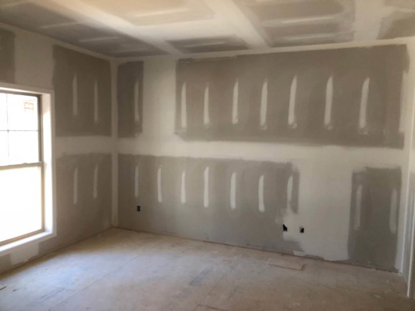 White-walled room with a large window, smooth white floor, and gray painted accents