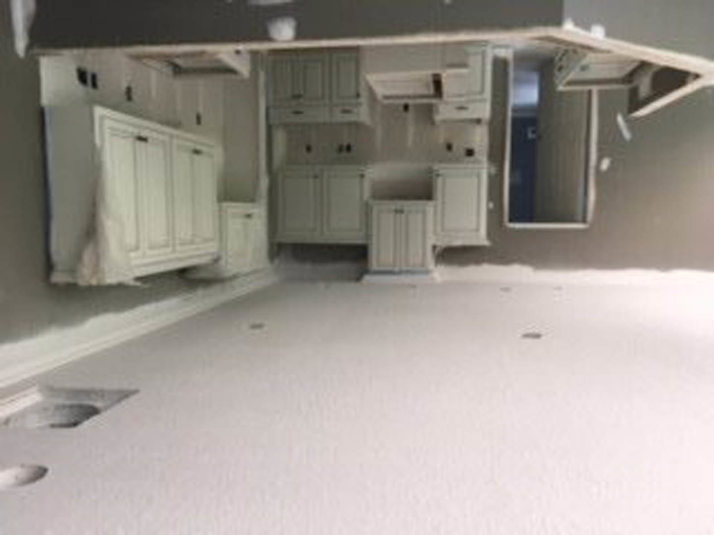 Open-concept room featuring white walls, white cabinetry, light wood flooring, and recessed ceiling lighting