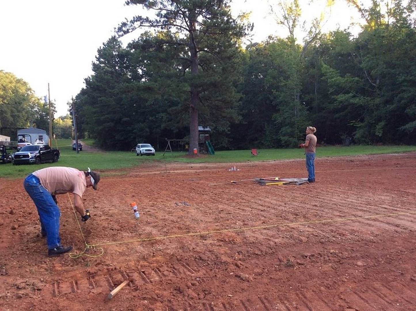 A man and woman working on a construction site.