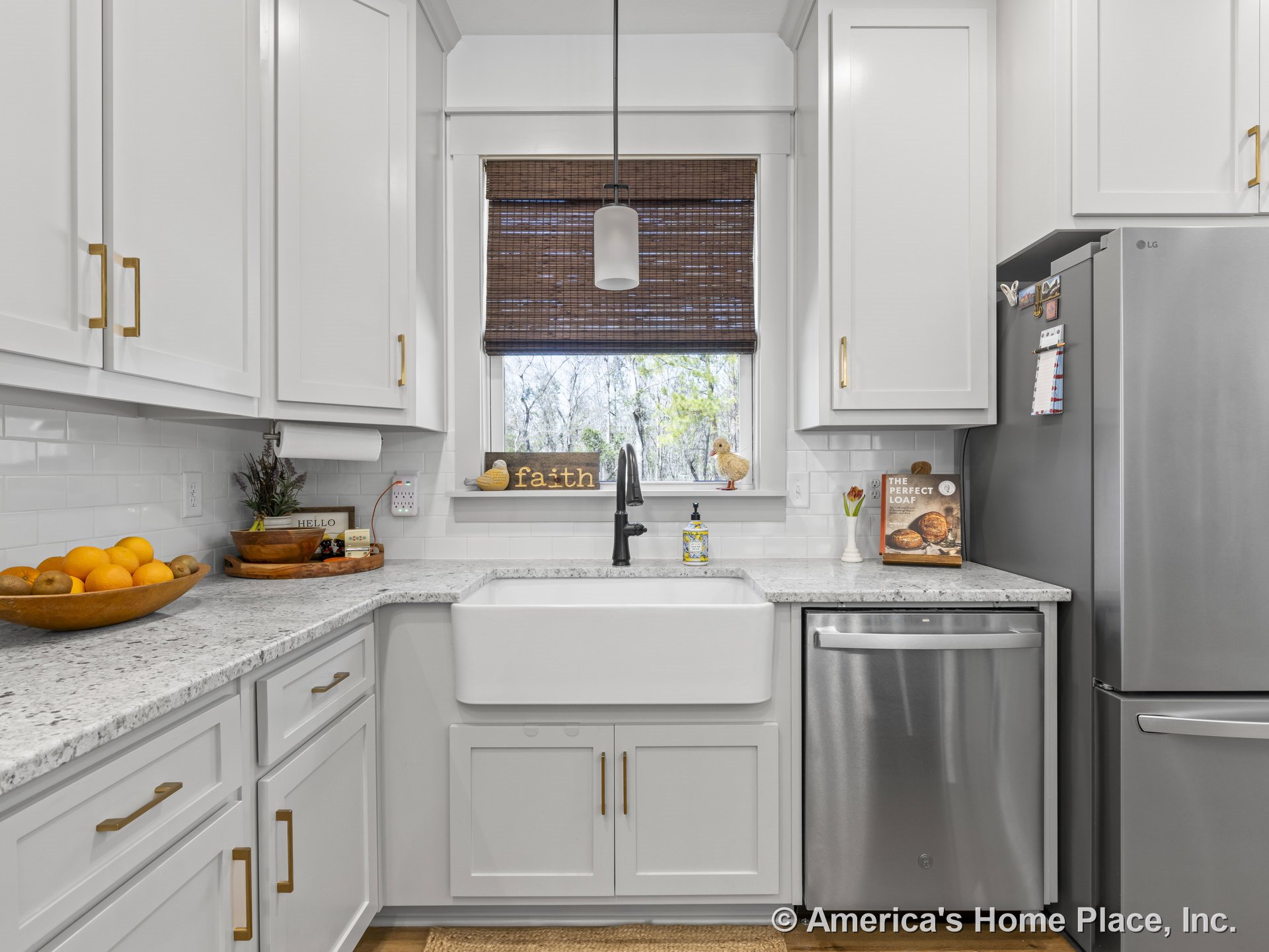 White shaker cabinets with granite countertops, farmhouse sink beneath a window, subway tile backsplash, stainless steel dishwasher and refrigerator, pendant lighting, hardwood