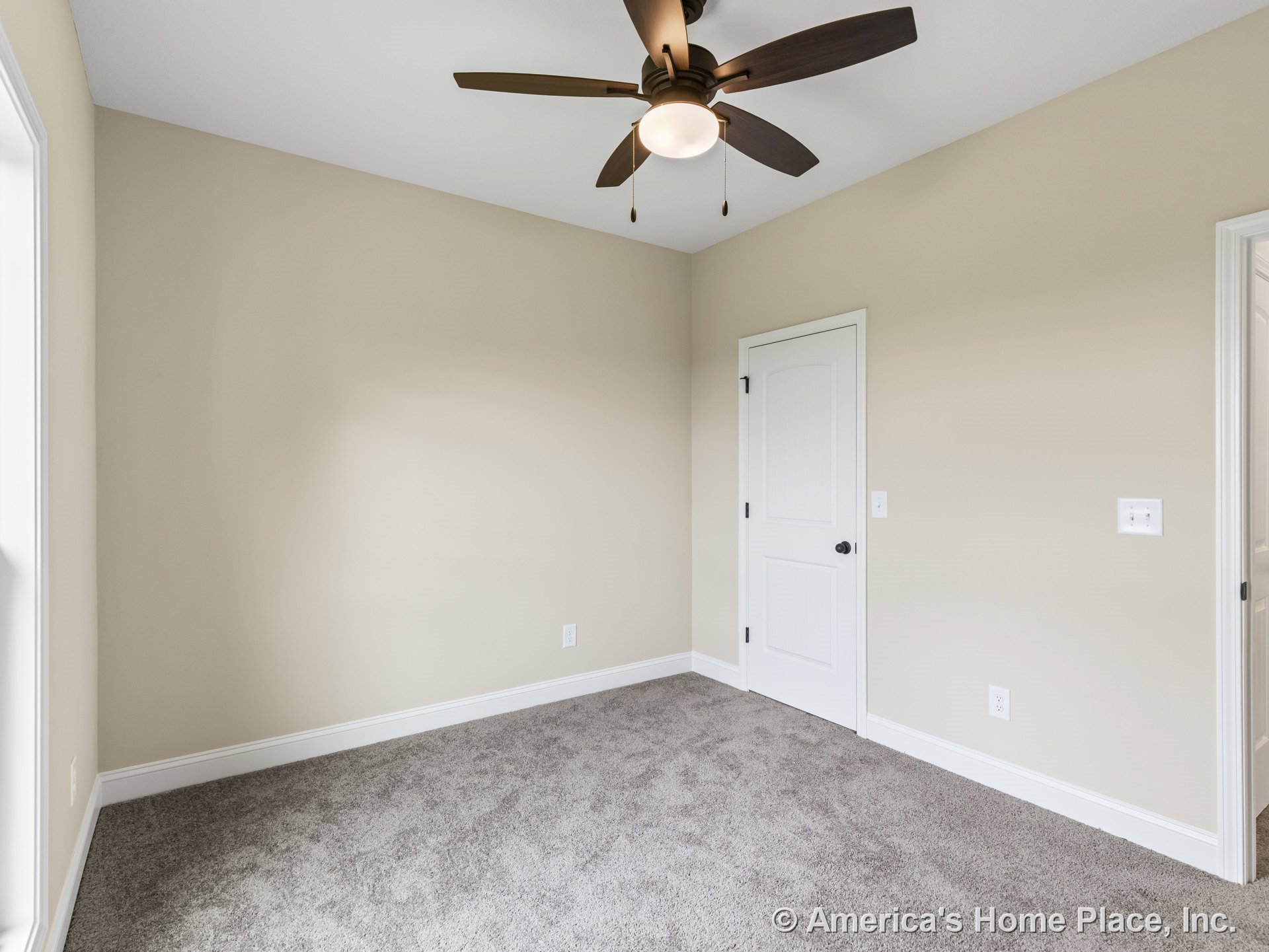 Bedroom with carpet flooring, beige walls, white baseboards and trim, ceiling fan with integrated light, window framed in white, white interior and closet doors, modern electrical