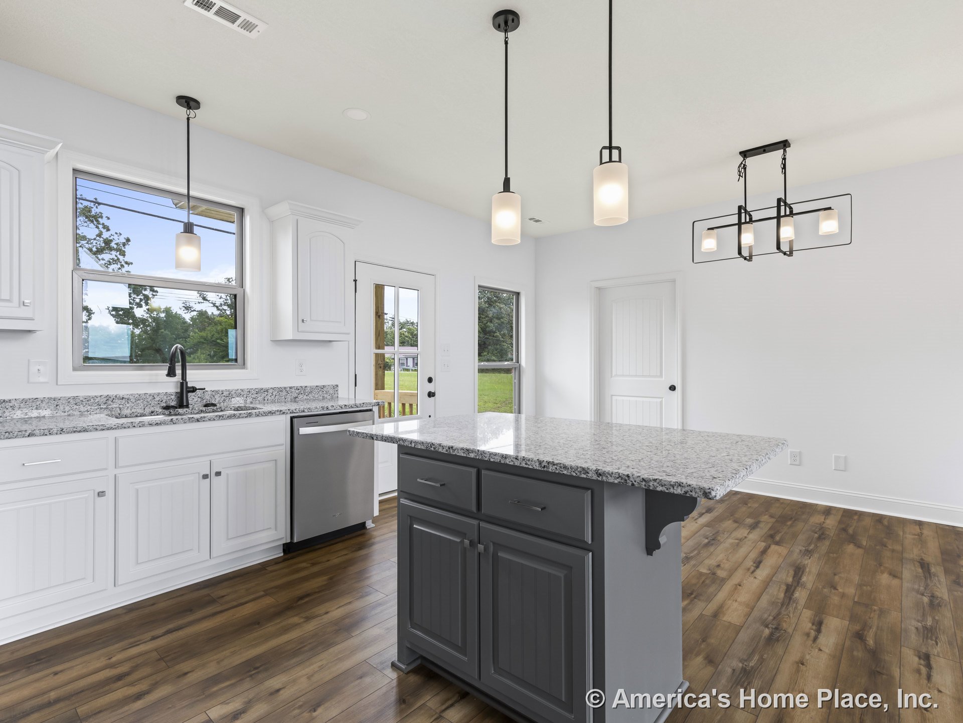 Granite kitchen island with white shaker cabinets, stainless steel dishwasher, wood-look flooring, modern pendant lights, and window above sink.
