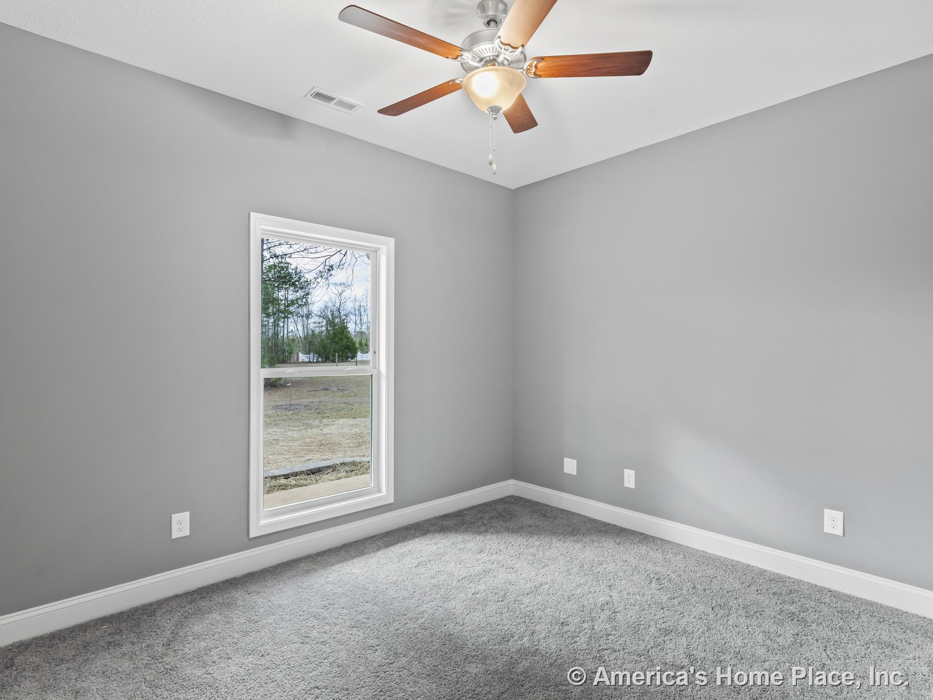 Bedroom with gray carpet flooring, light gray walls, large window framed in white trim, ceiling fan with integrated light fixture, white baseboards, and multiple electrical