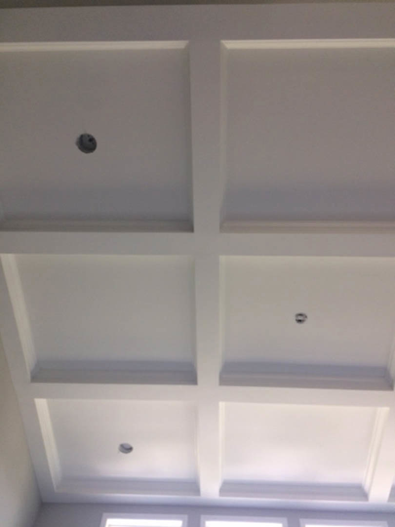 White plaster ceiling with a circular hole, surrounded by smooth walls in a residential interior.