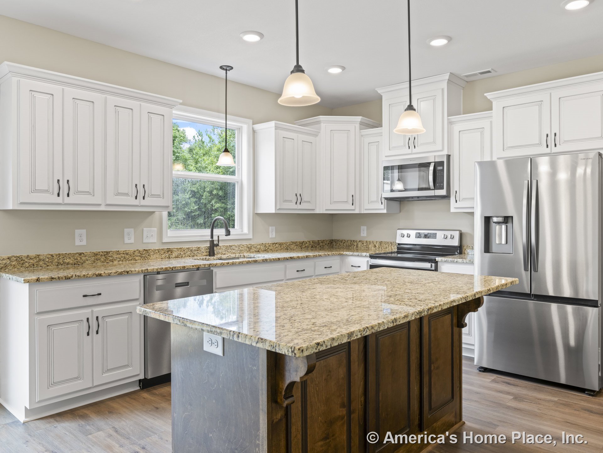 White upper and lower kitchen cabinets with granite island countertop, stainless steel refrigerator, built-in microwave above electric range, double sink, dishwasher, wood-look