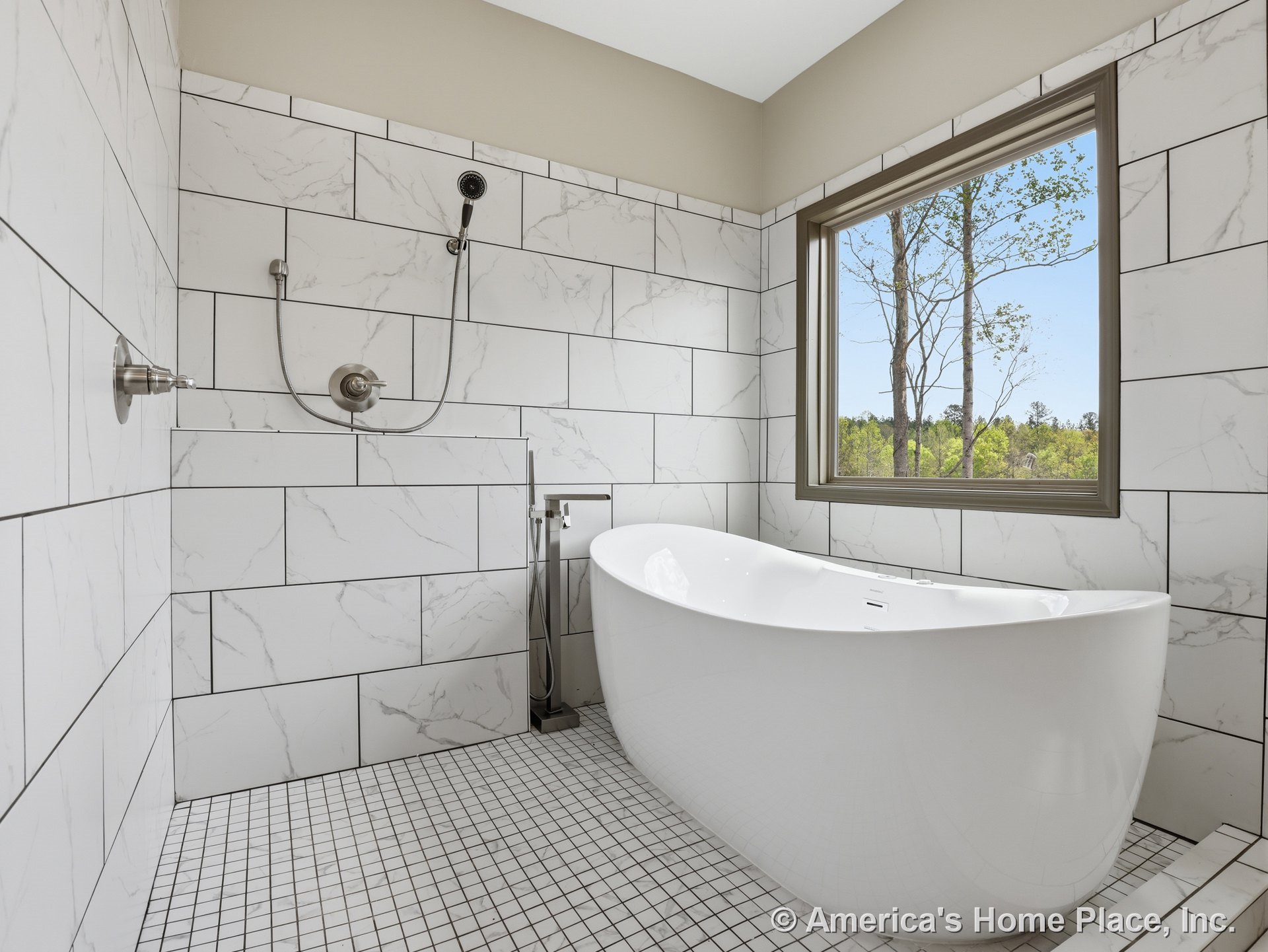 Freestanding soaking tub set against large marble-look wall tiles, walk-in shower fixtures, square mosaic floor tile, expansive picture window, and neutral wall trim in a modern