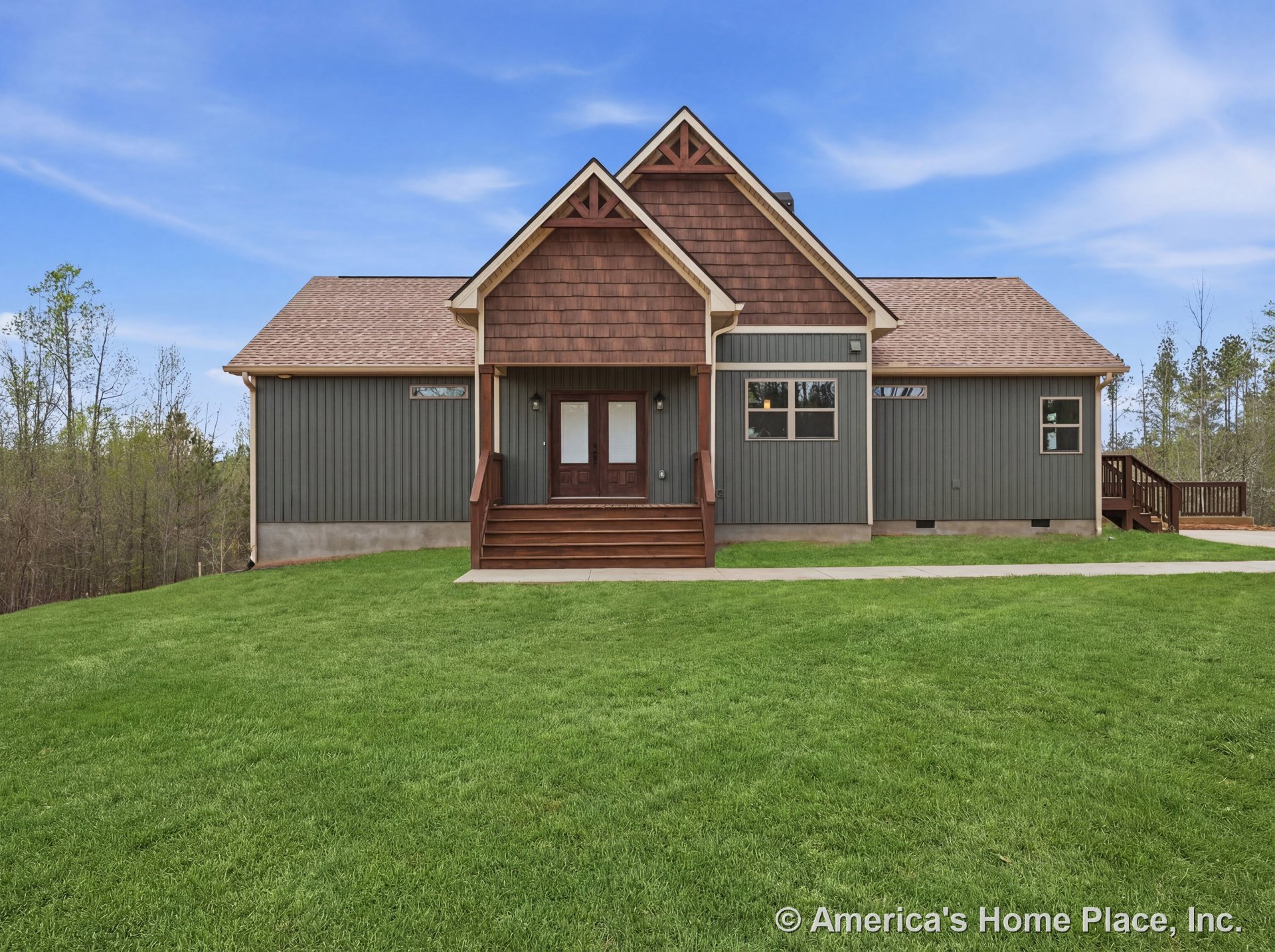 Gabled roof with architectural shingles, wood siding and shingle accents, trimmed windows, covered front porch with wood railings and wood steps, double entry doors, concrete