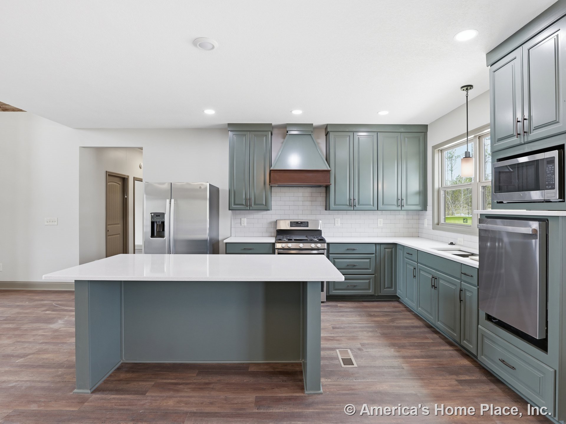 Green shaker cabinets with quartz countertops, large kitchen island, subway tile backsplash, stainless steel appliances including built-in microwave and oven, gas range, pendant