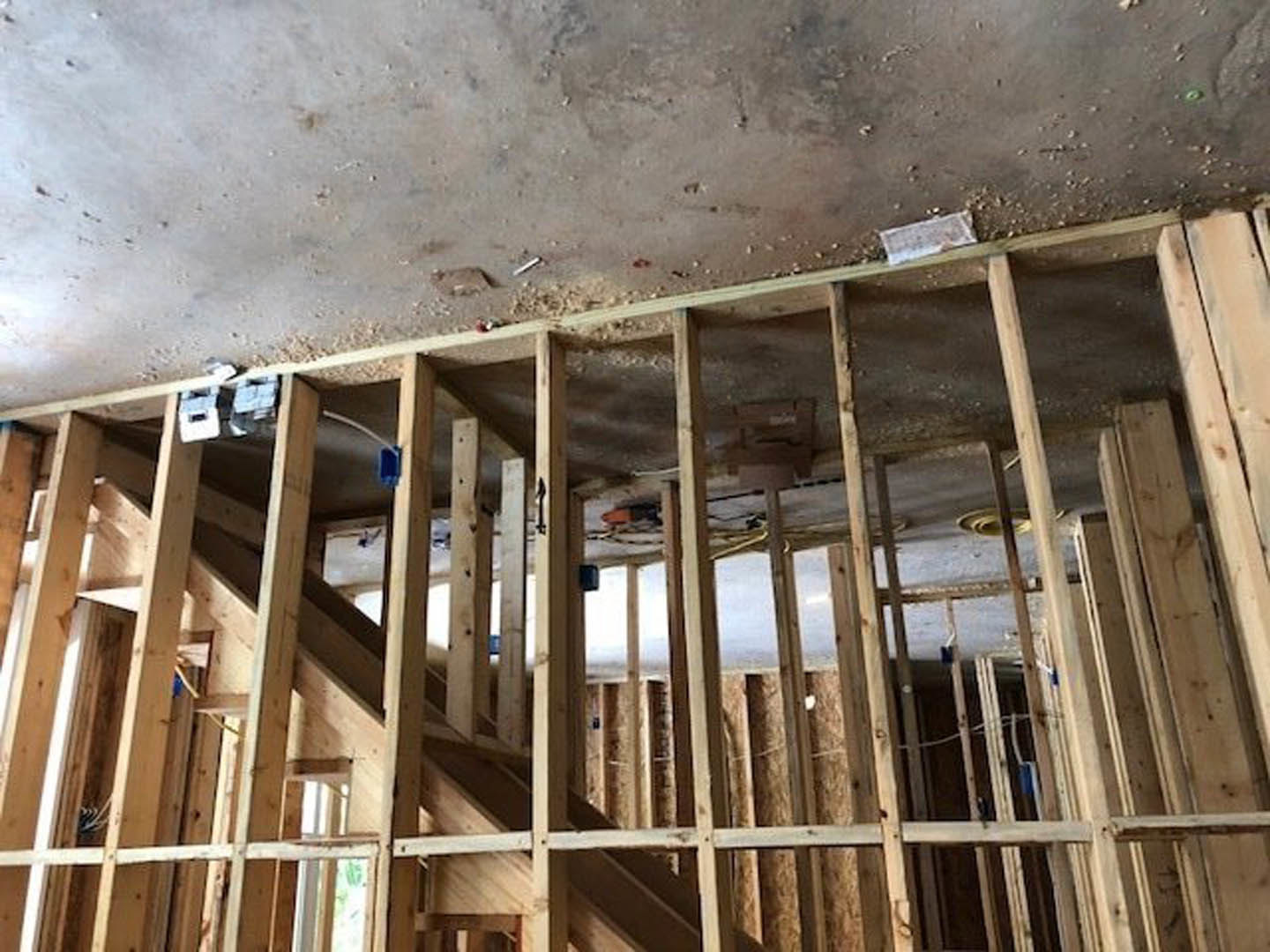 Exposed wood framing and beams inside unfinished residential structure