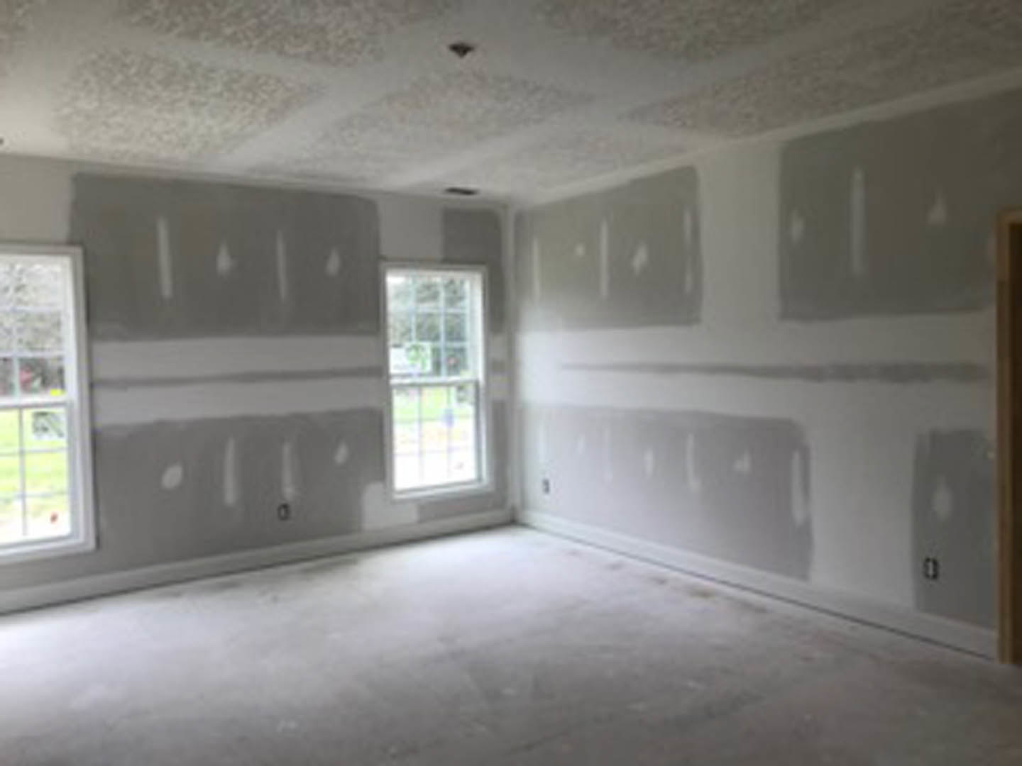 White walls, large window with clear glass pane, white carpeted floor, smooth plaster ceiling