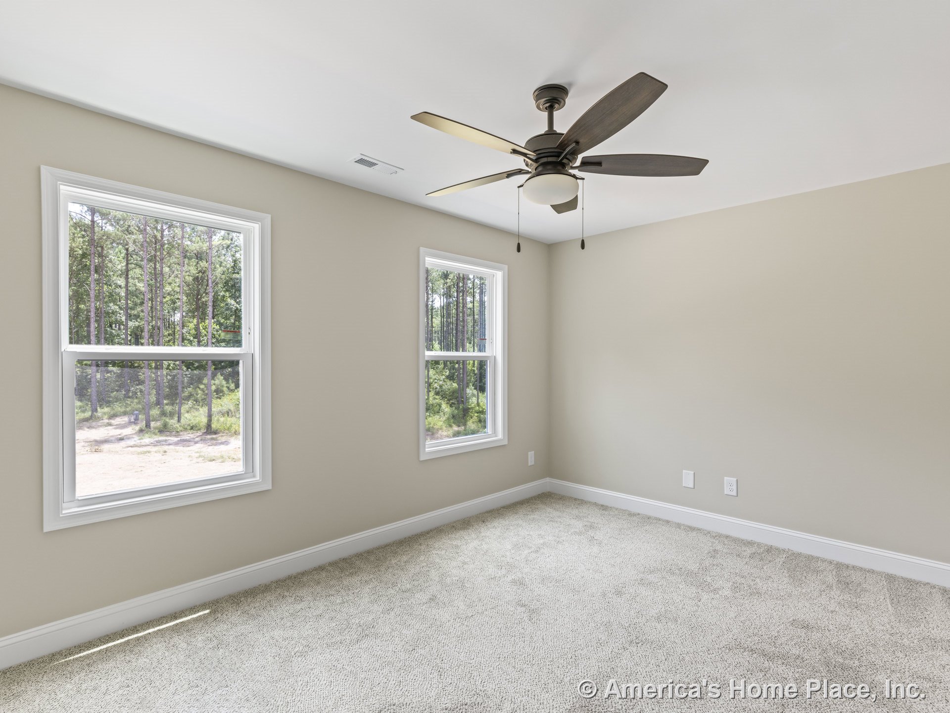 Bedroom with two large windows, beige walls, white trim and baseboards, carpet flooring, recessed ceiling, ceiling fan with integrated light, electrical outlets, and air vent.