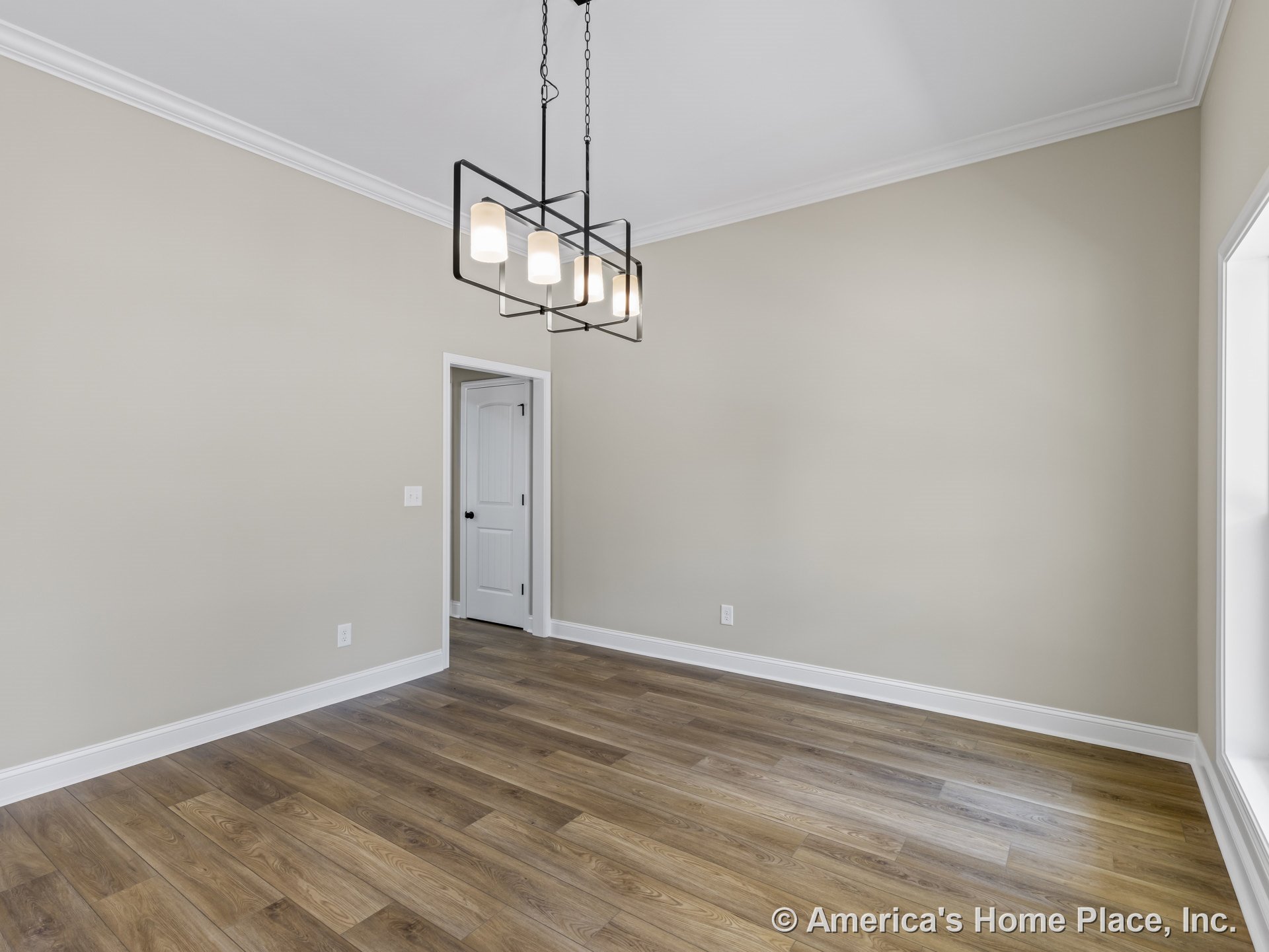 Dining room with wood-look plank flooring, beige walls, white crown molding, white trim and baseboards, modern rectangular black chandelier, and interior panel door.