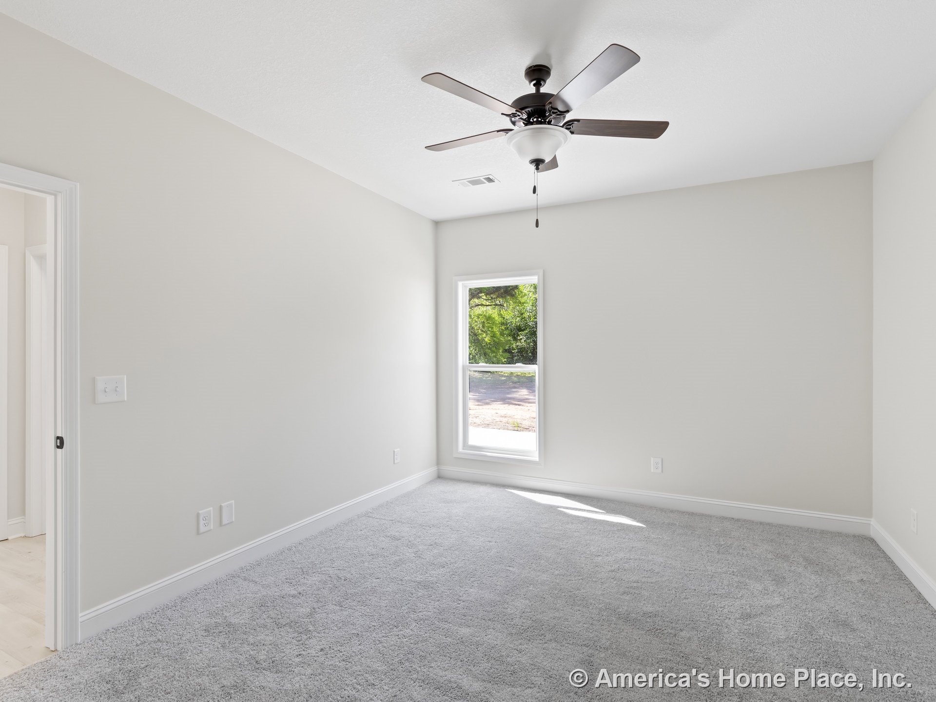 Bedroom with light gray carpet flooring, white trim and baseboards, single window with white frame, ceiling fan and integrated light fixture, neutral wall color, and standard
