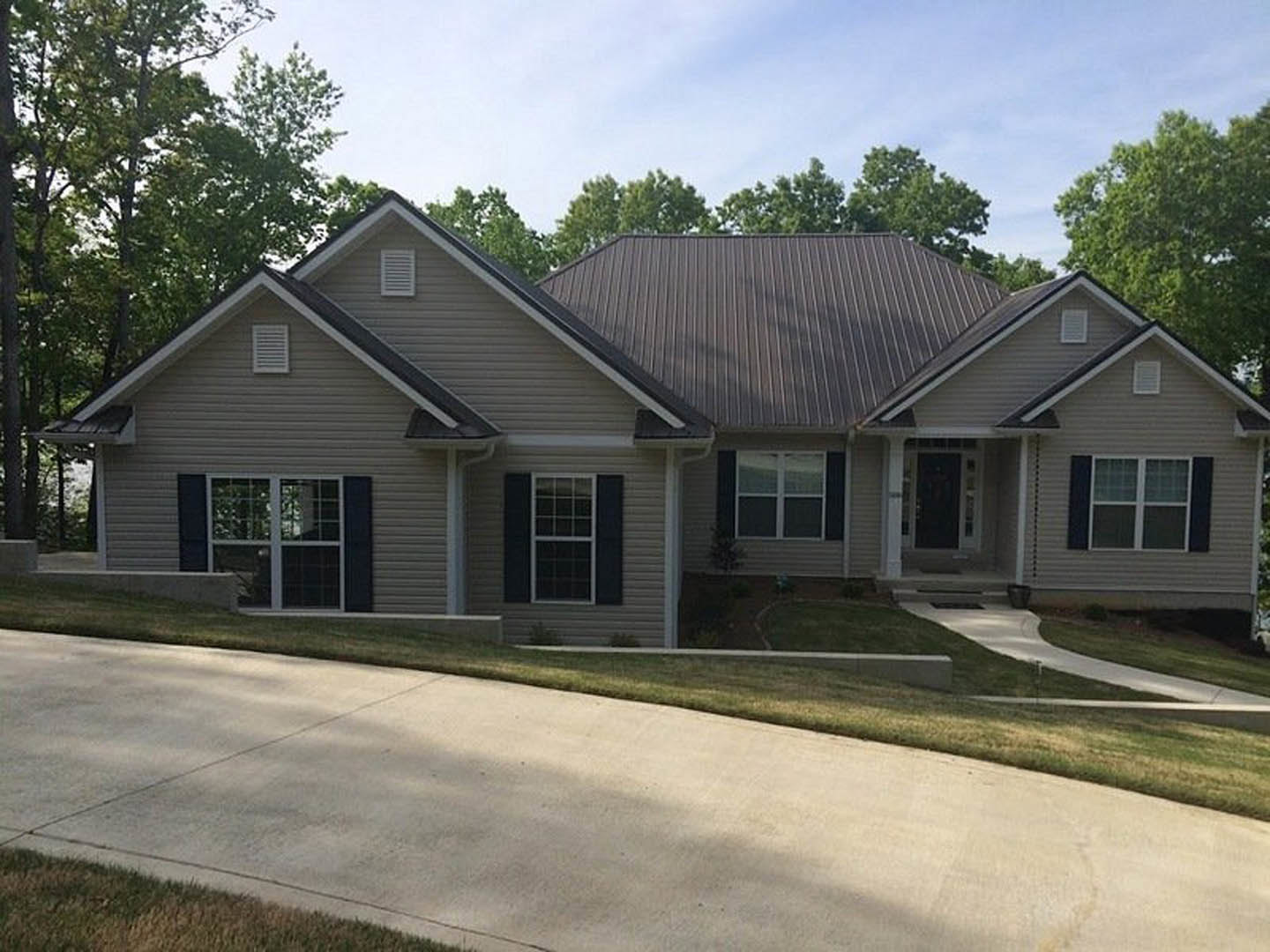 A house with a driveway and trees.