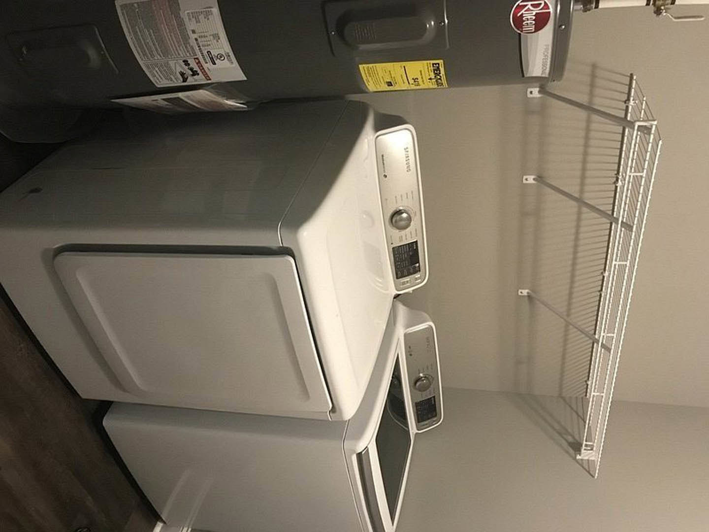 A dryer and a dryer in a laundry room.