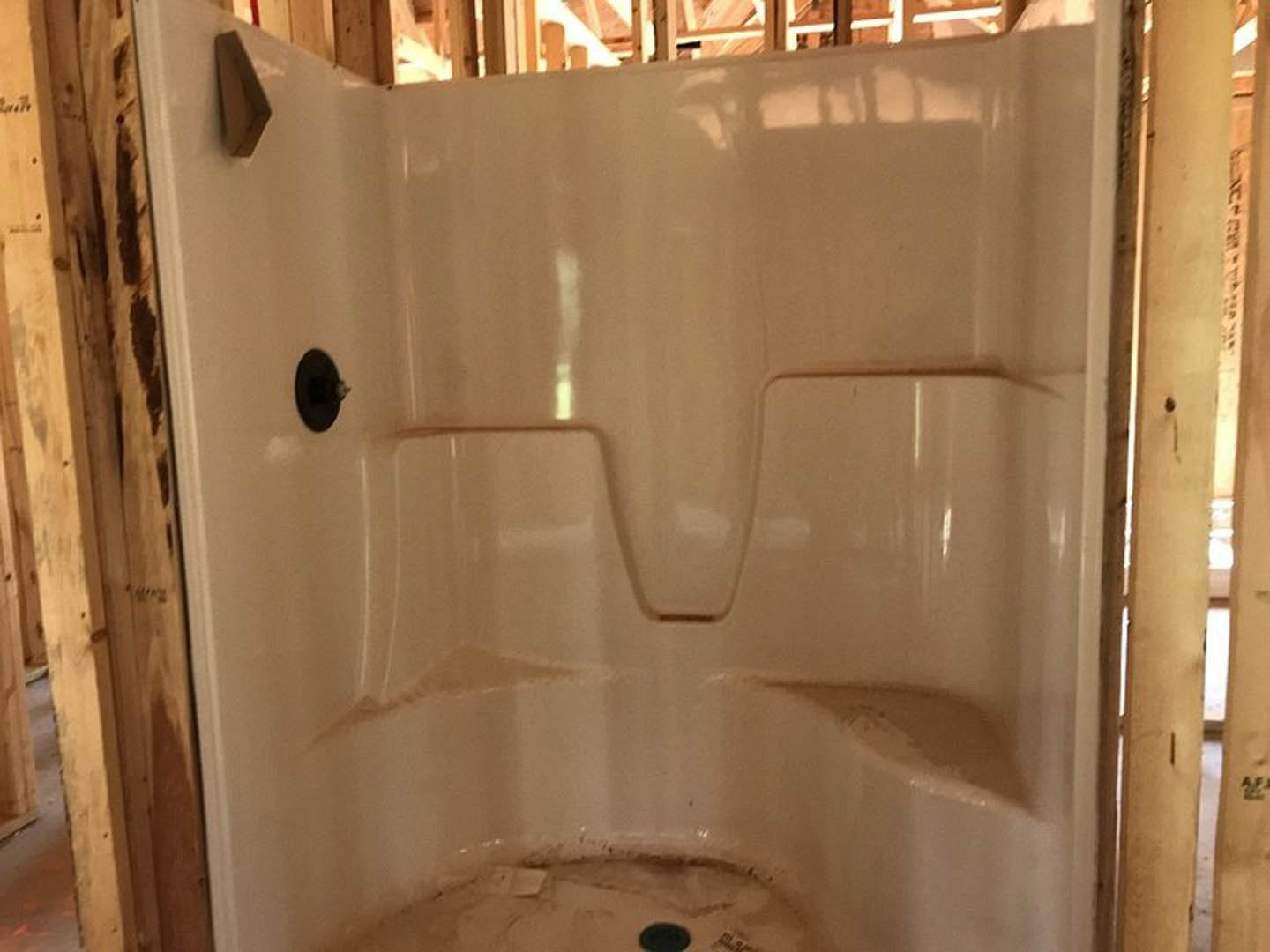 Walk-in shower with glass enclosure, large-format stone tile walls, built-in niche, and chrome fixtures in a modern bathroom