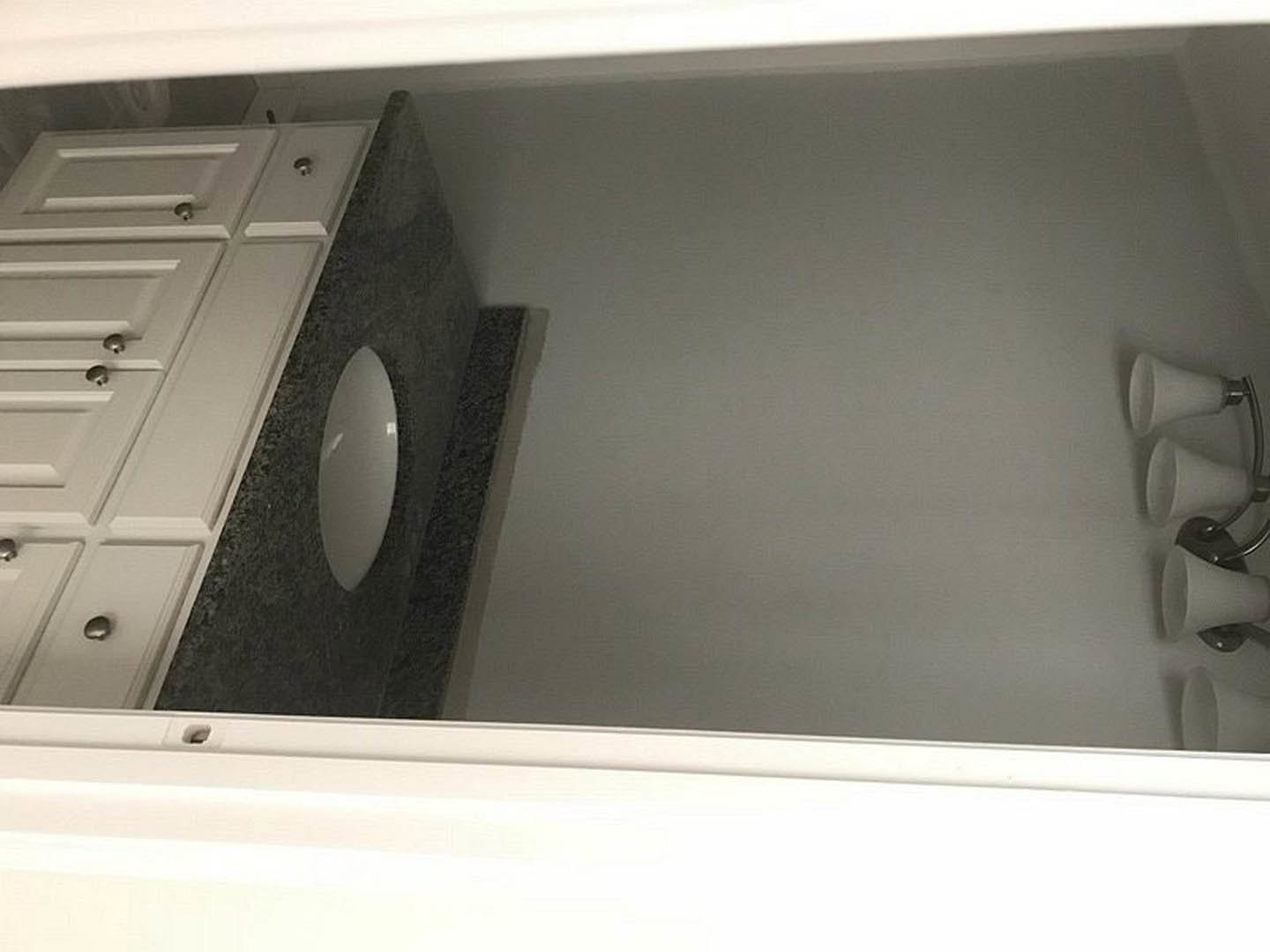 Modern bathroom featuring a white ceramic sink, chrome faucet, light-colored countertop, and a wall-mounted toilet paper holder against neutral-toned walls