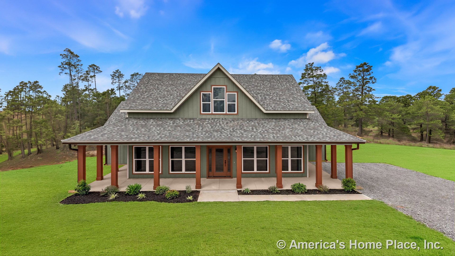 Large covered front porch with wood columns, double front door, multiple large windows, gray shingle roof, green vertical siding, white trim, landscaped front yard, and paved