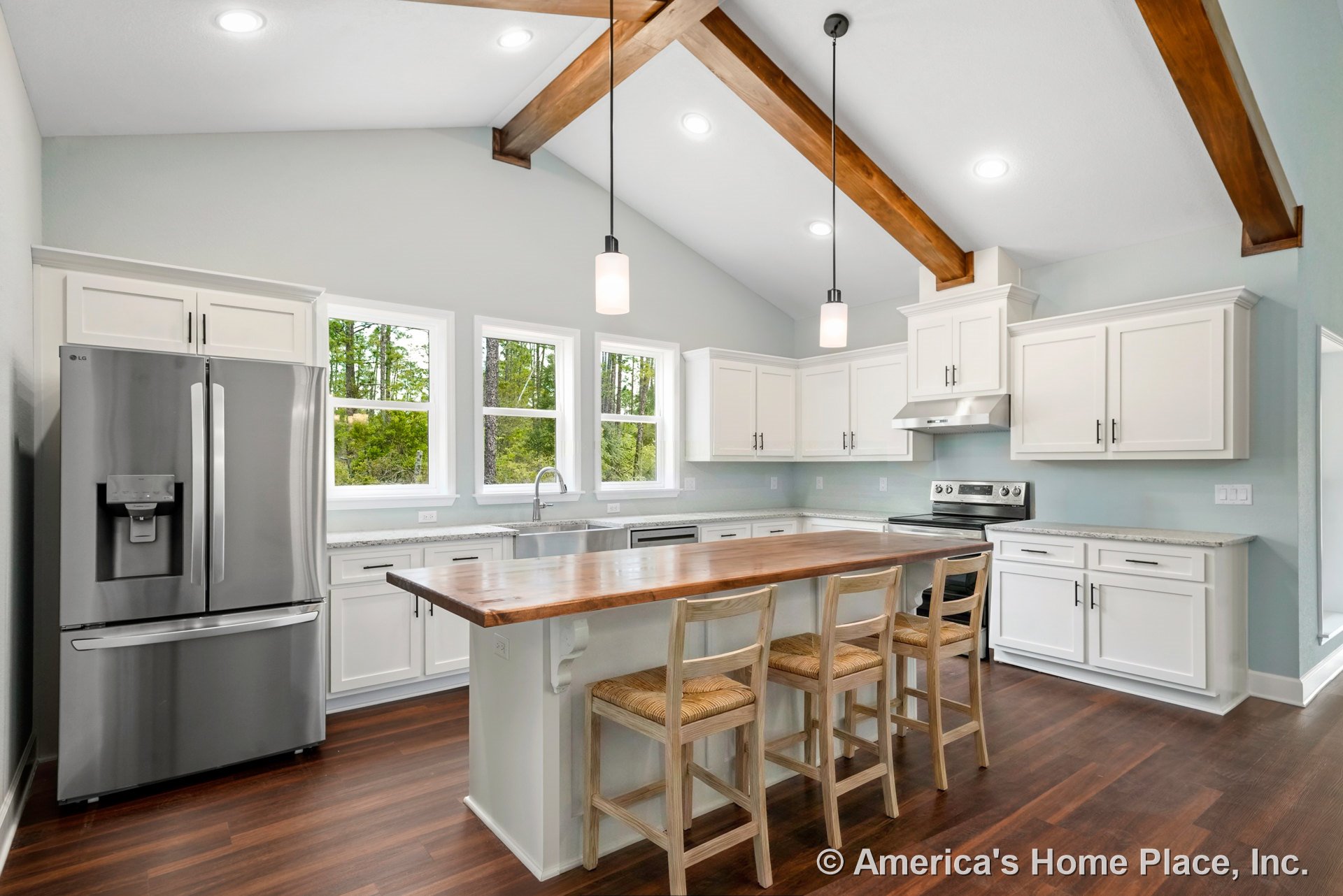 Vaulted kitchen ceiling with exposed wood beams, white shaker cabinets, granite countertops, pendant and recessed lighting, stainless steel appliances including refrigerator and