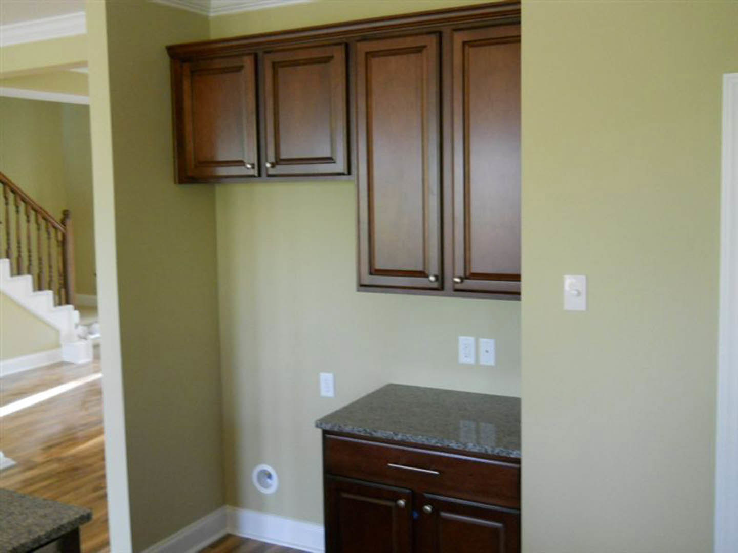 Kitchen featuring natural wood cabinets, white marble countertop, stainless steel sink, and modern drawer pulls