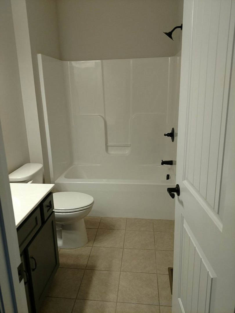 A bathroom with a toilet and tub.