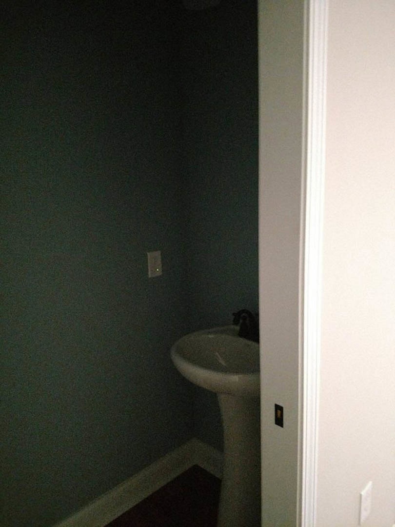 White ceramic sink with chrome faucet set against light gray tiled wall in modern bathroom