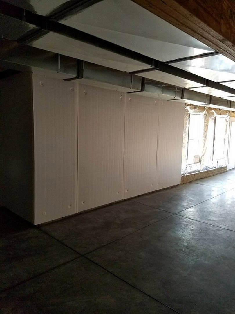 White walls with smooth plaster finish, rectangular tile flooring, metal vent set into wall, large window with minimal trim, exposed ceiling beam.