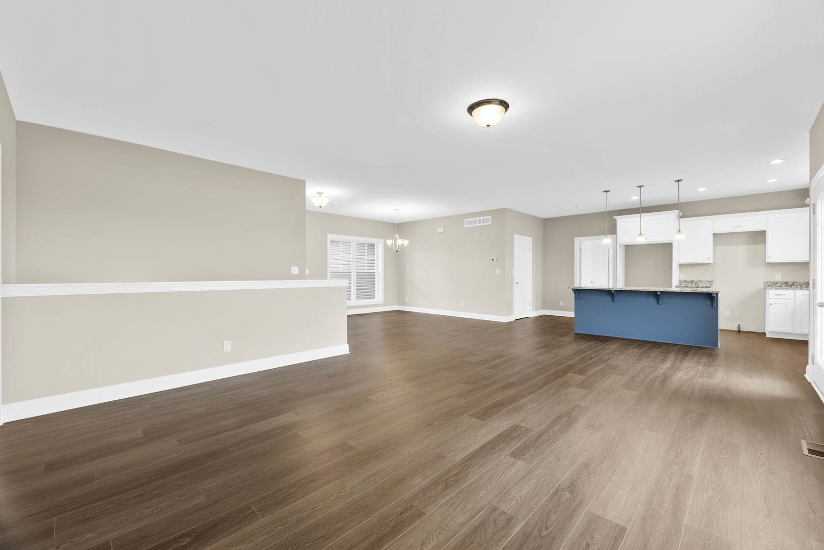 Hardwood floor room featuring a blue countertop against a blue wall, white window with blinds, recessed ceiling lights, and plaster ceiling