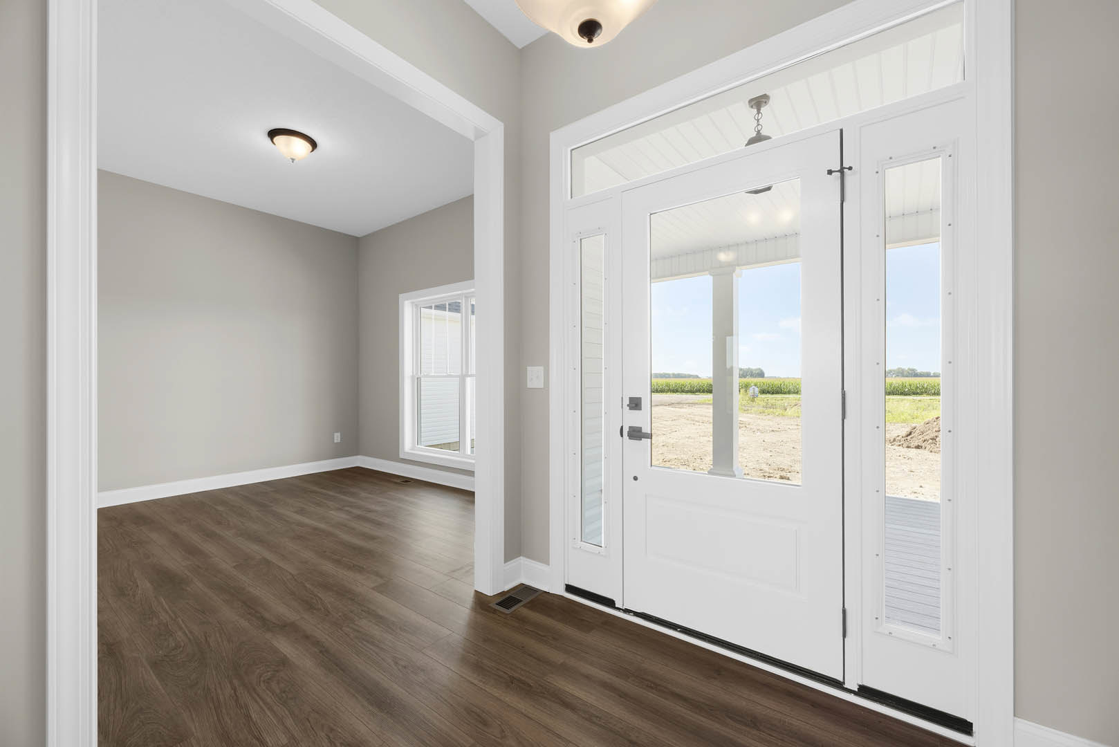 White paneled door with glass inserts, adjacent glass doors, wood laminate flooring, white walls with crown molding, floor vent, and recessed ceiling light
