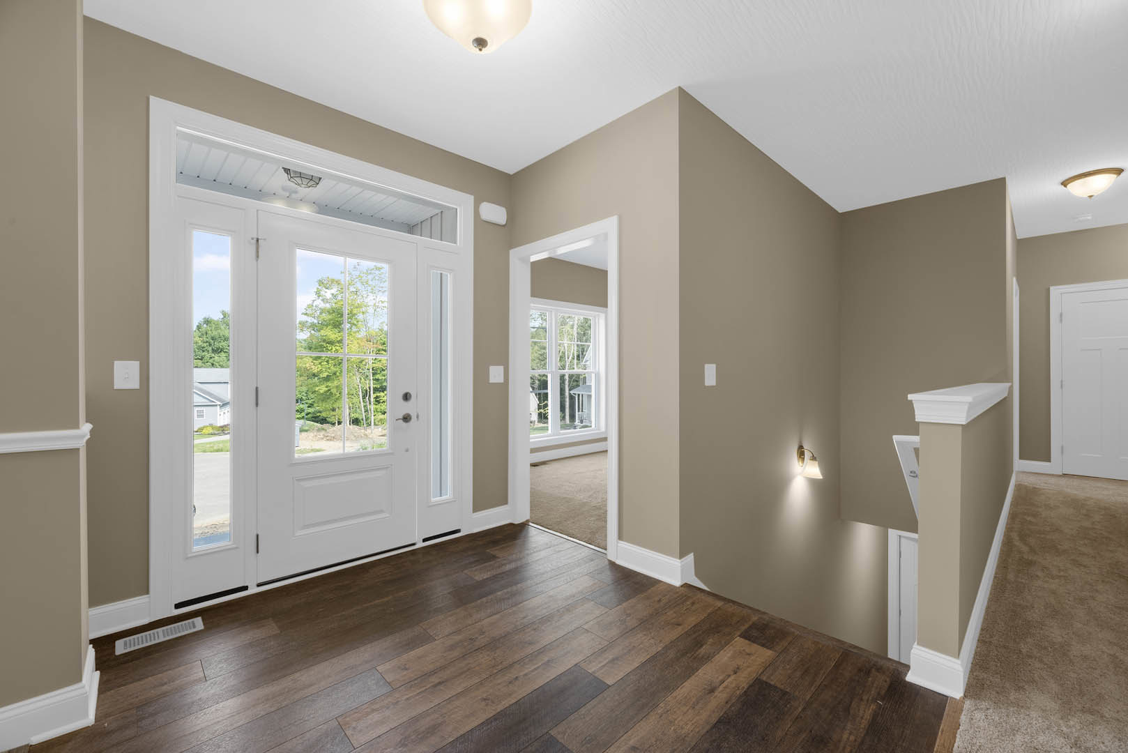 Hallway with white paneled doors, wood plank flooring, white plaster walls, and a ceiling-mounted light fixture