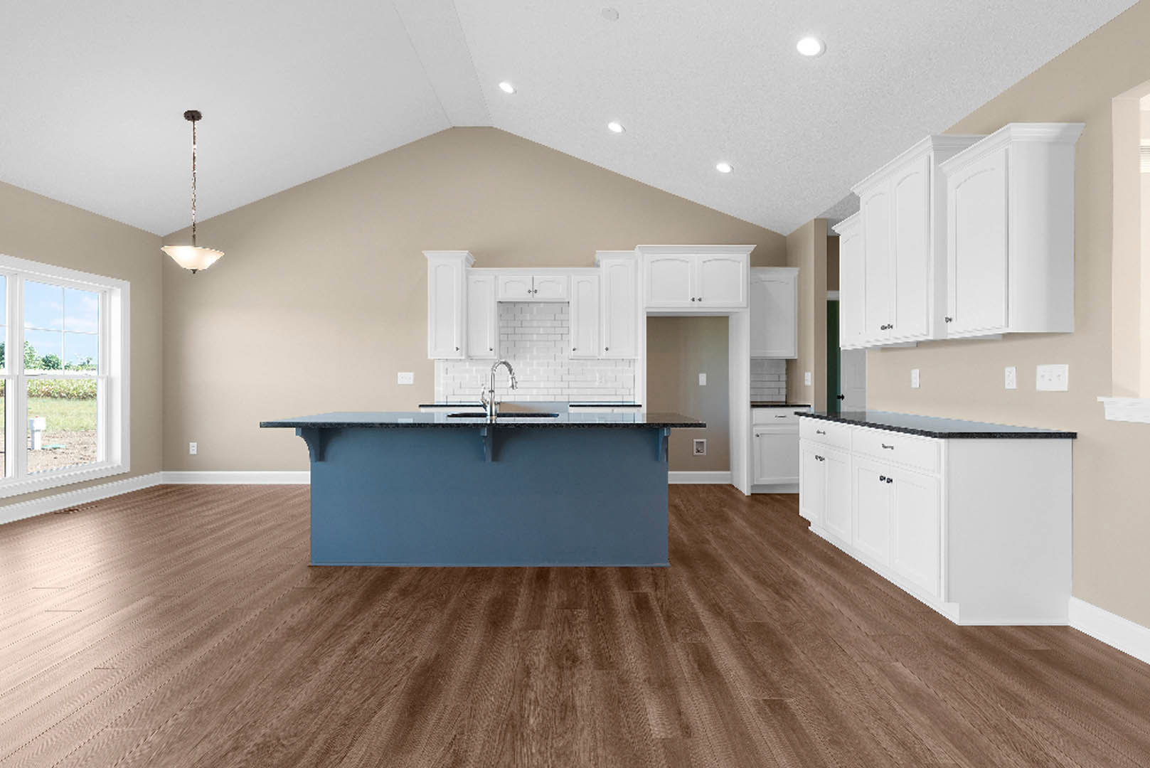 Blue kitchen island with white cabinets, wooden flooring, stone countertop, and window overlooking green lawn