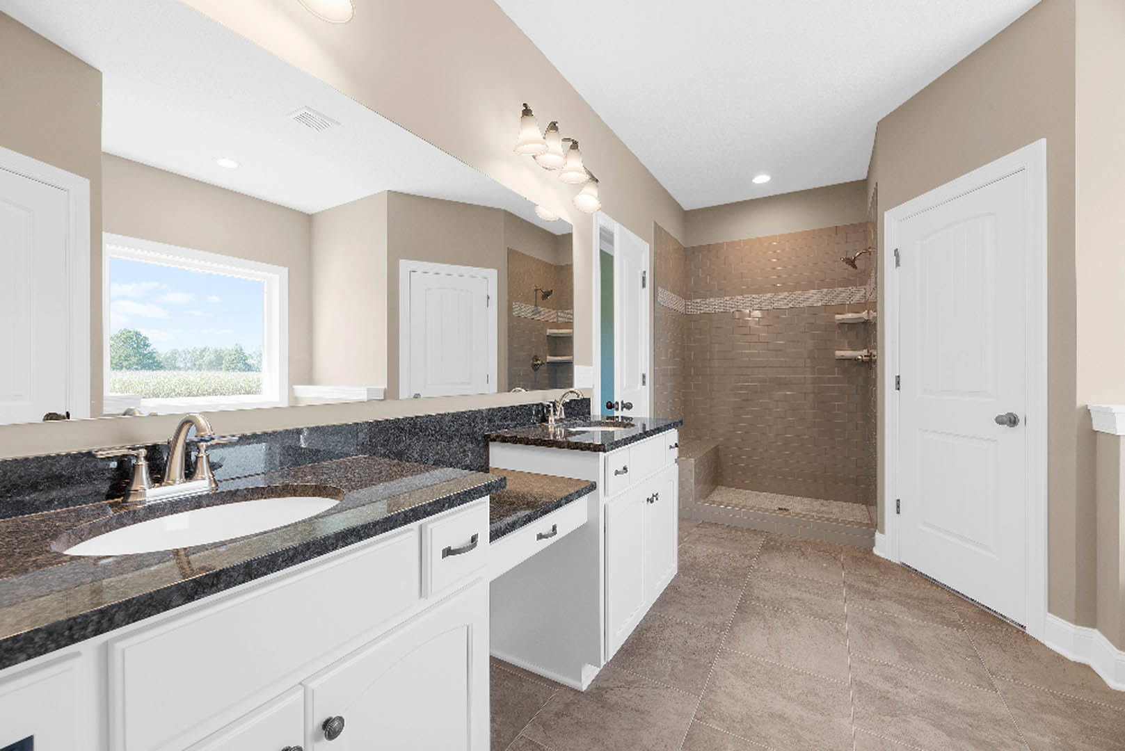 Bathroom featuring a wide mirror above a rectangular sink, quartz countertop, row of wall-mounted lights, white cabinetry, silver faucet, tile flooring, window overlooking trees