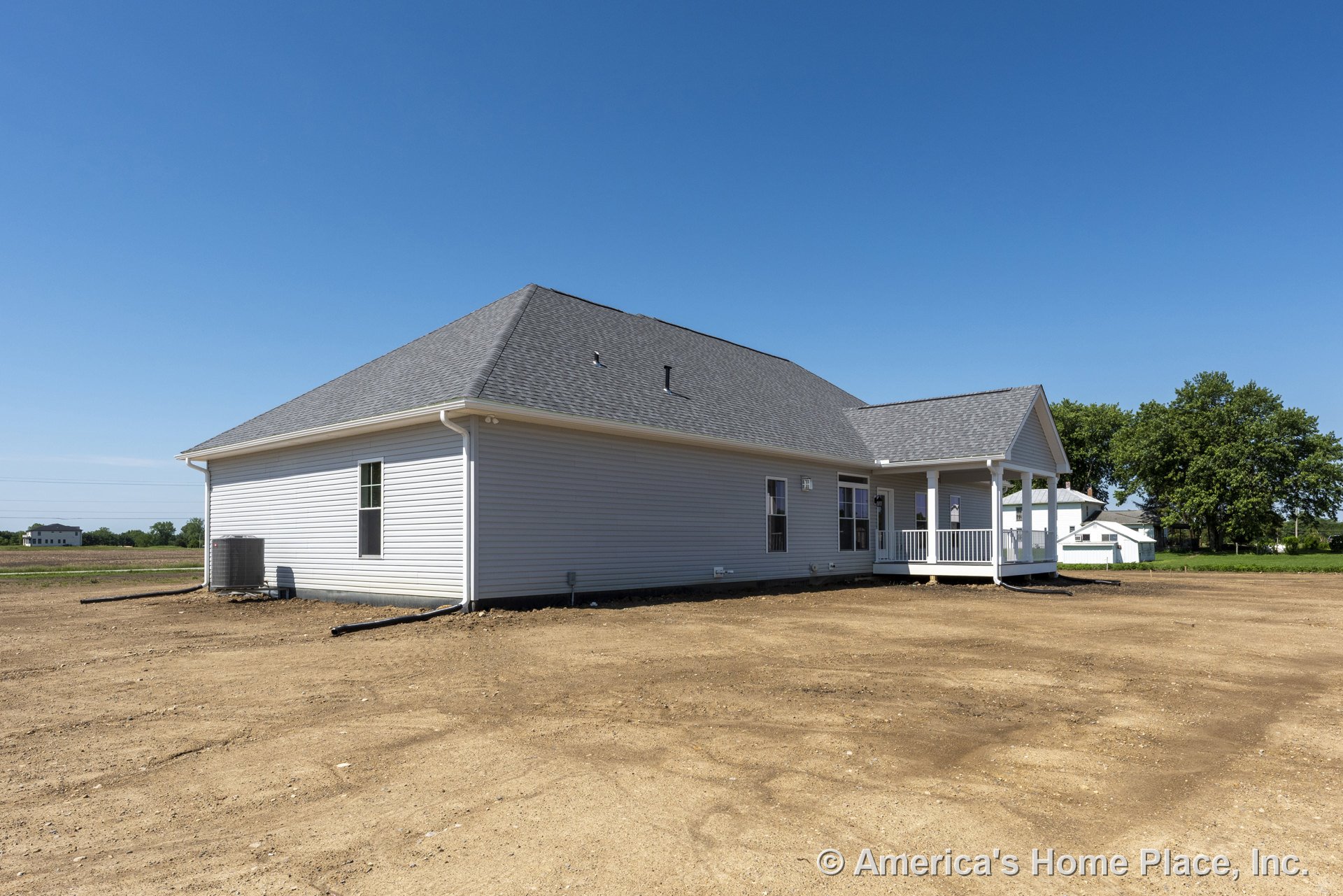 Single-story home with gray vinyl siding, hip roof with asphalt shingles, covered porch featuring white railing, multiple double-hung windows, central air conditioning unit, and