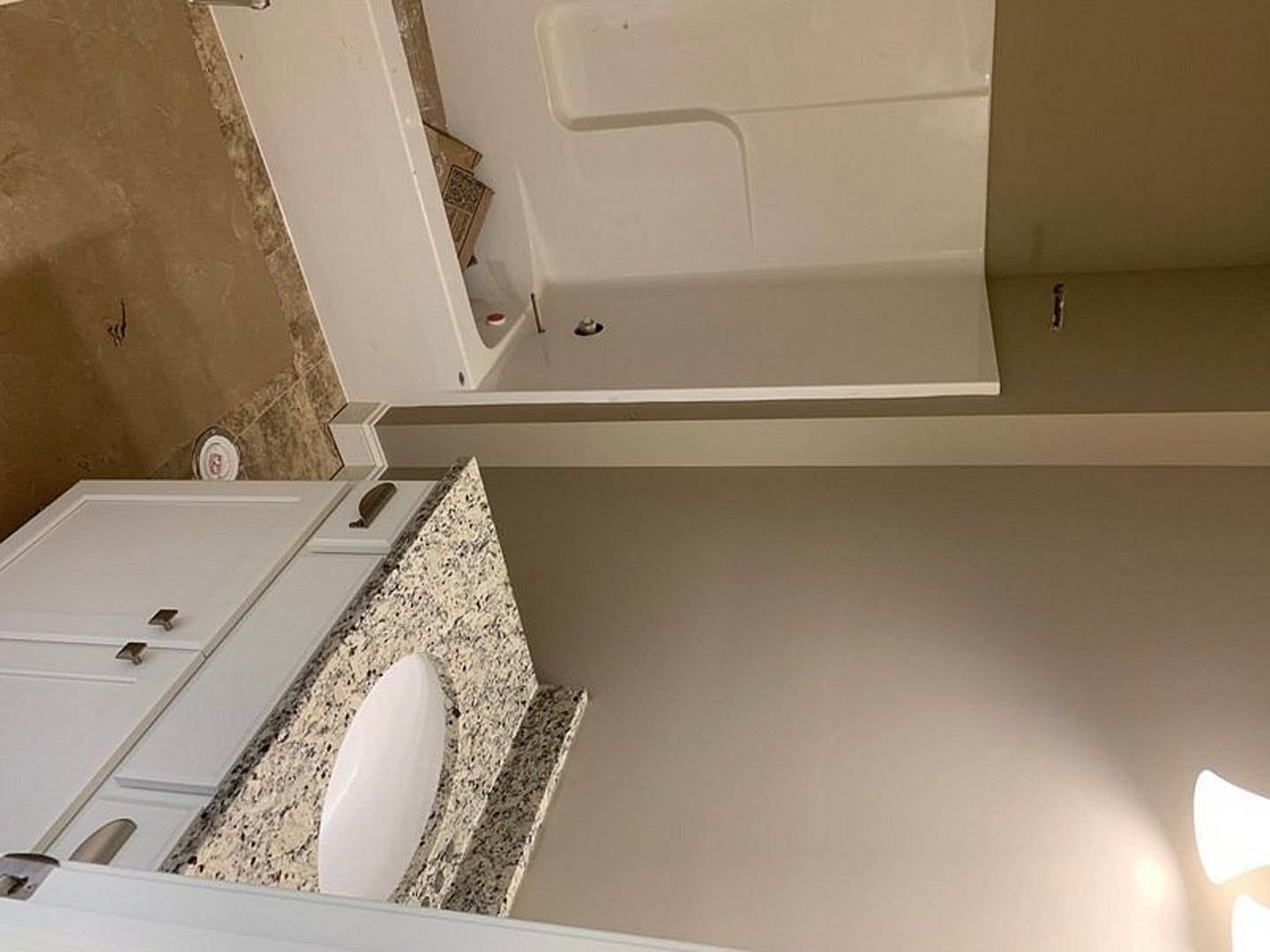 Modern bathroom featuring a white vanity with undermount sink, glass-enclosed shower with chrome fixtures, large format tile walls, and recessed lighting.