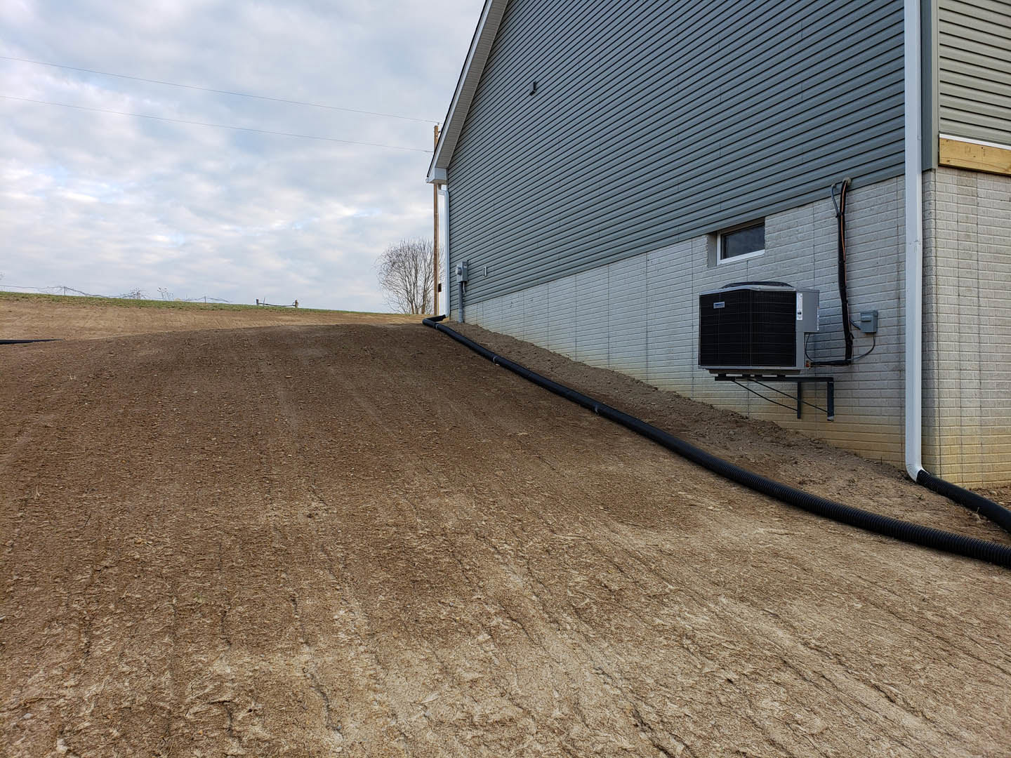 A large black tube on a building.
